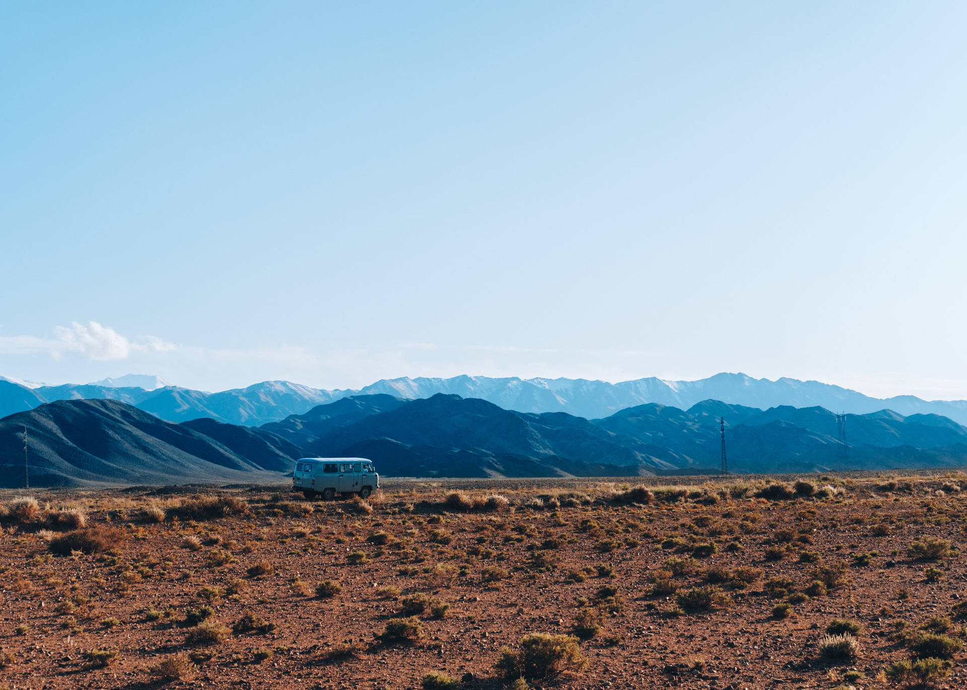 brown field near mountains during daytime