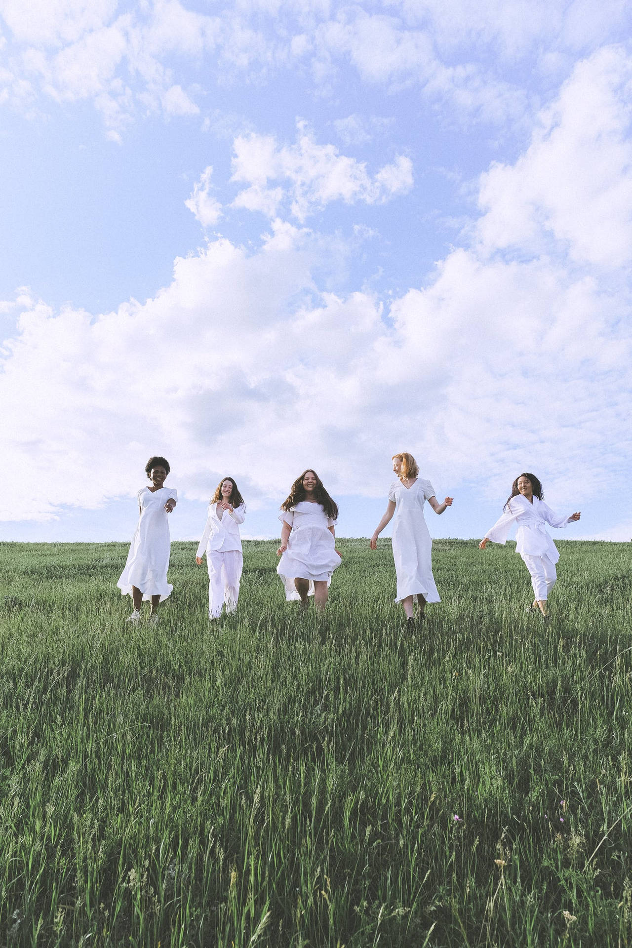Free Group of People Standing on Green Grass Field Under Blue Sky Stock Photo