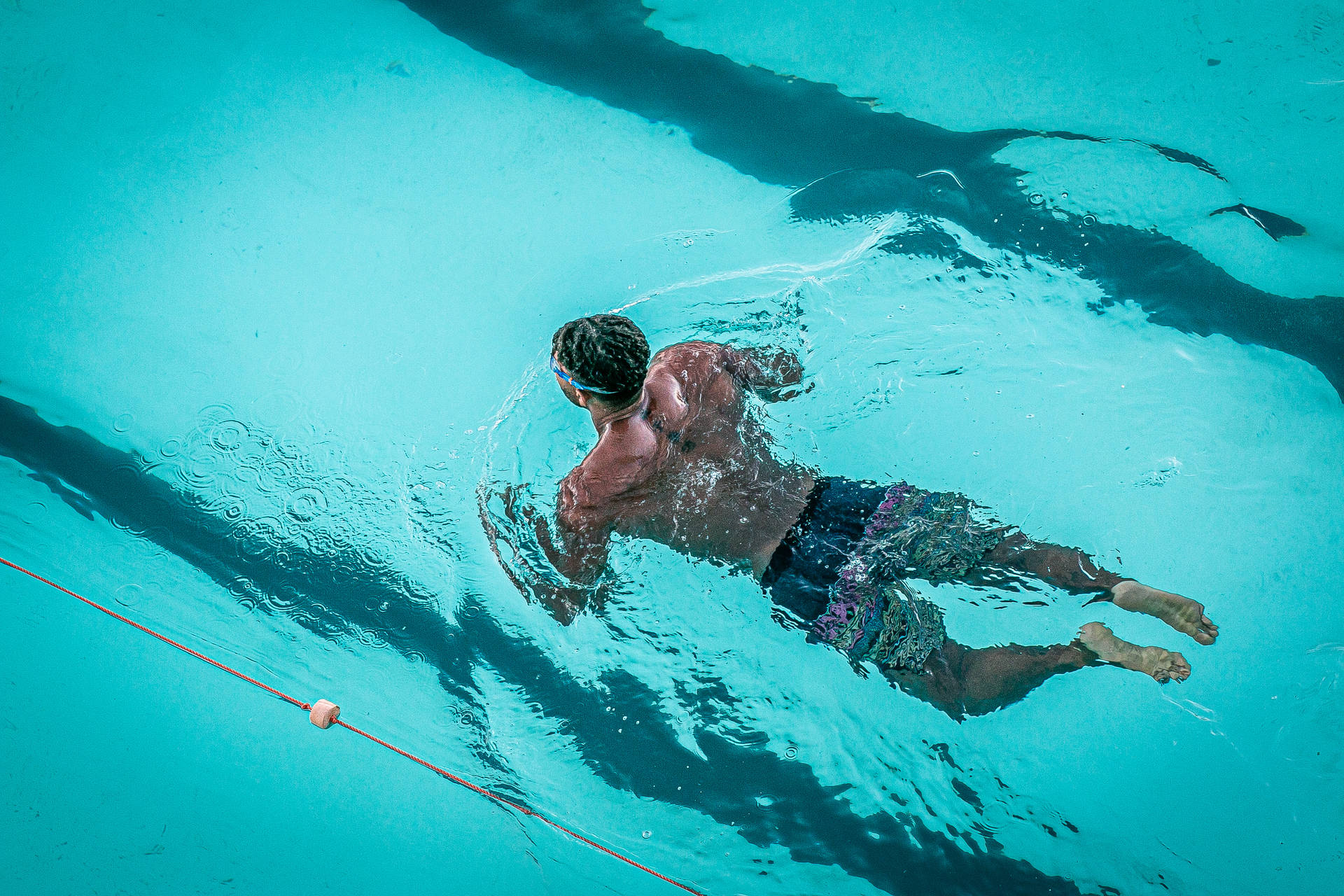 man swimming in pool