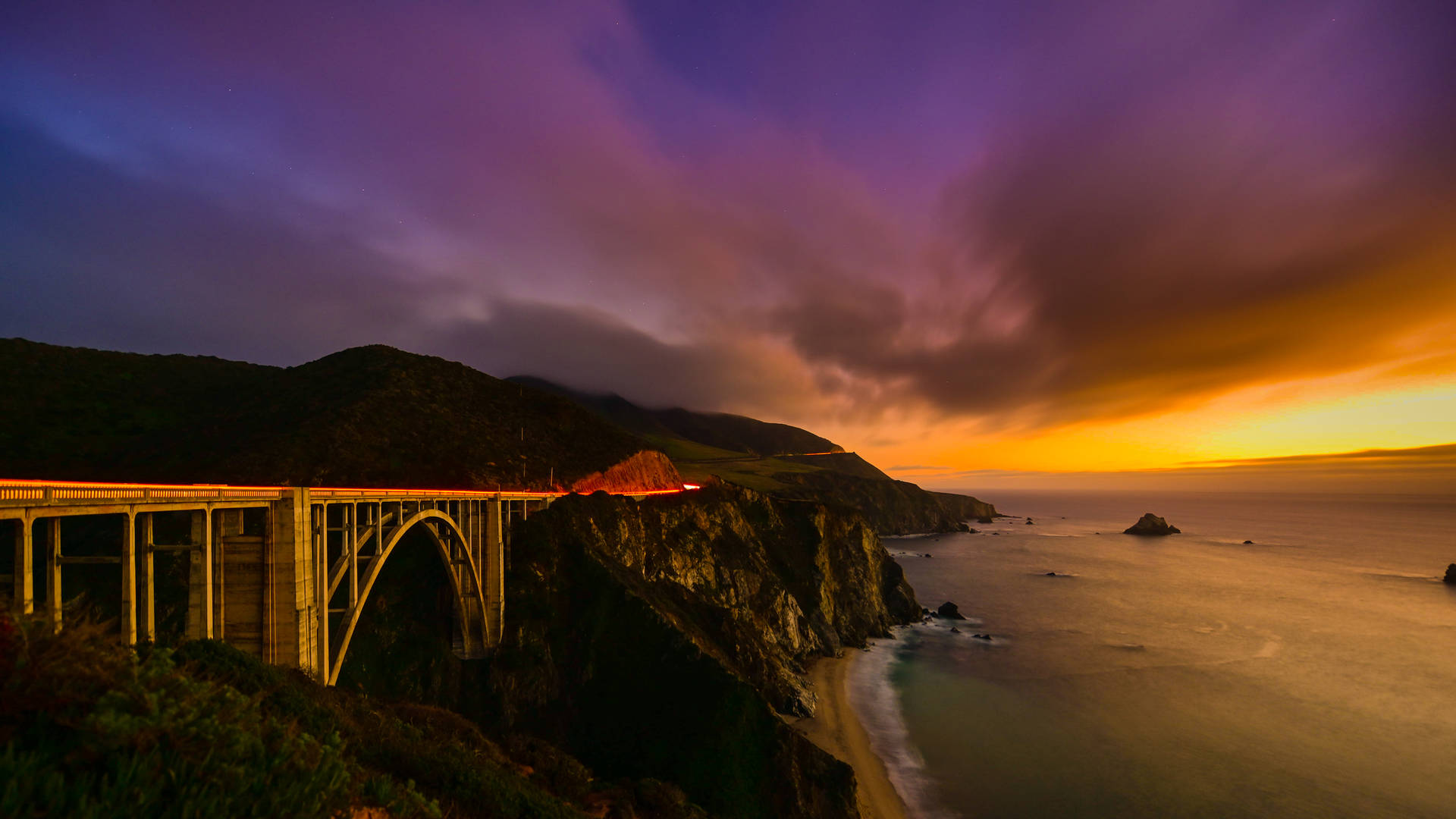 brown suspension bridge beside body of water