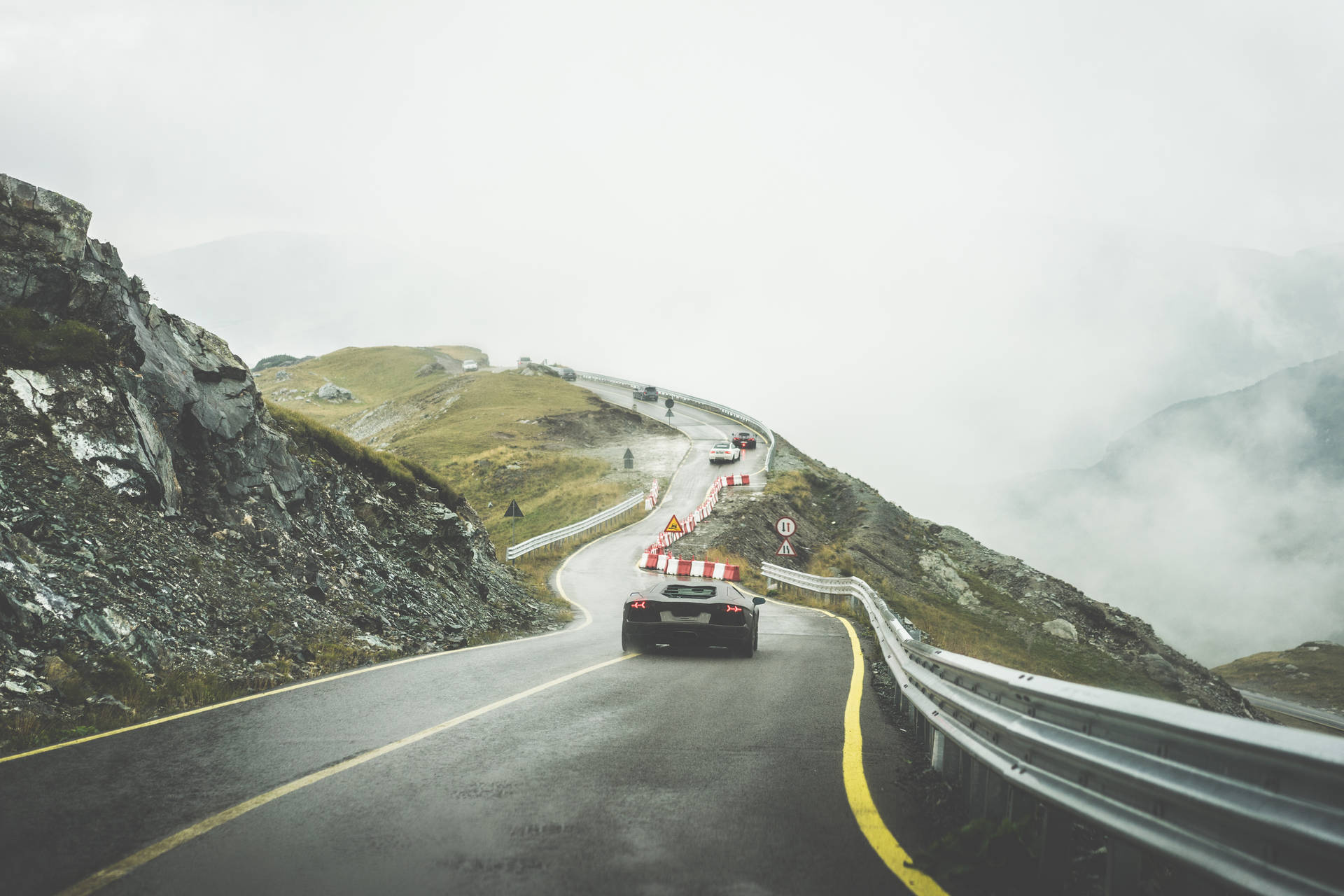 Download Sport Cars on Wet Mountain Road in Rainy Weather FREE Stock Photo