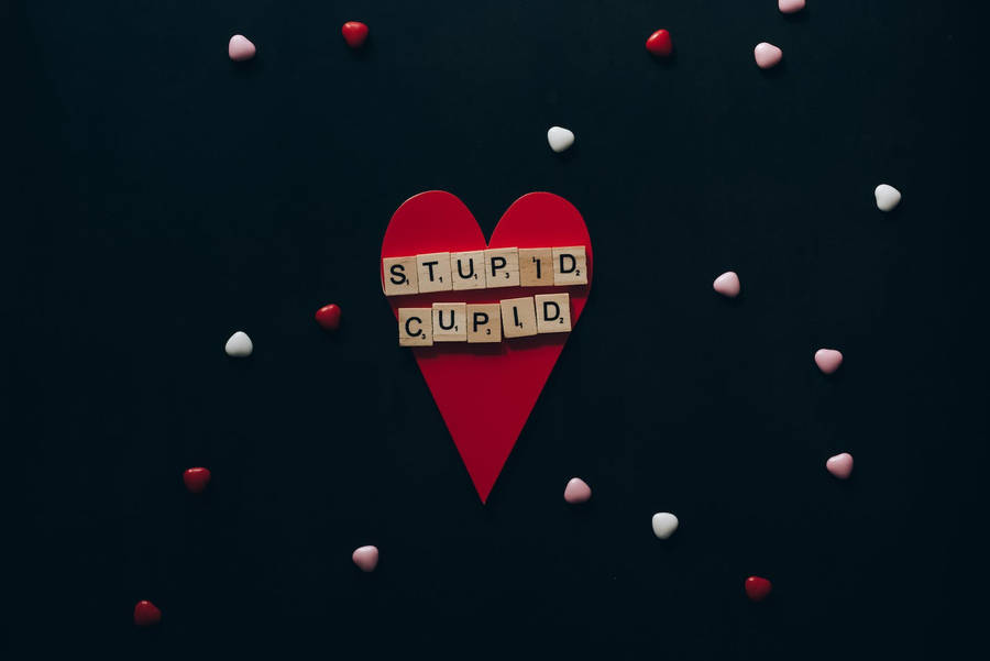 Free Wooden Scrabble Tiles on Red Paper Heart Stock Photo