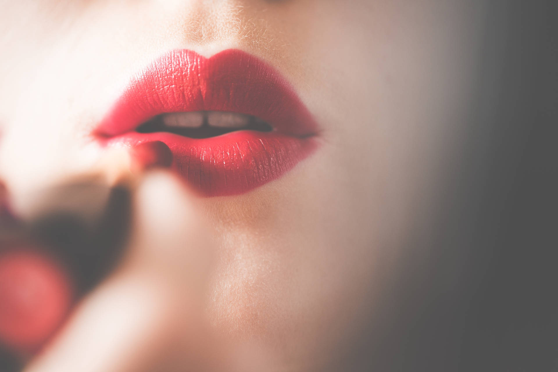 Download Young & Pretty Woman Applying Red Lipstick on Lips FREE Stock Photo