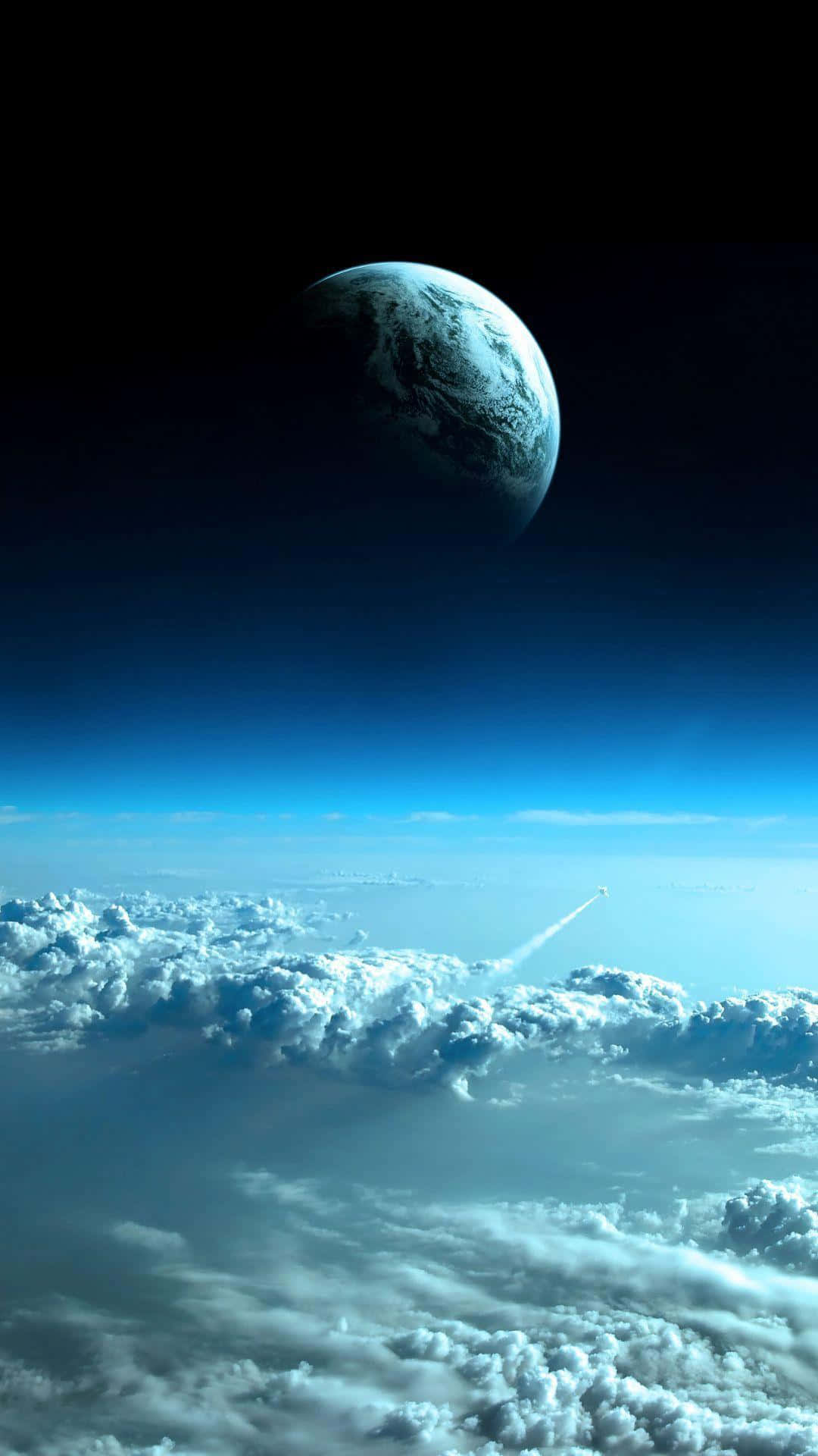 舞者剪影與自然交融 壁紙 — 從雲層上方俯瞰的壯麗景色，地球如一顆藍色彈珠，襯托著太空的黑色虛空，火箭尾跡劃破大氣層。