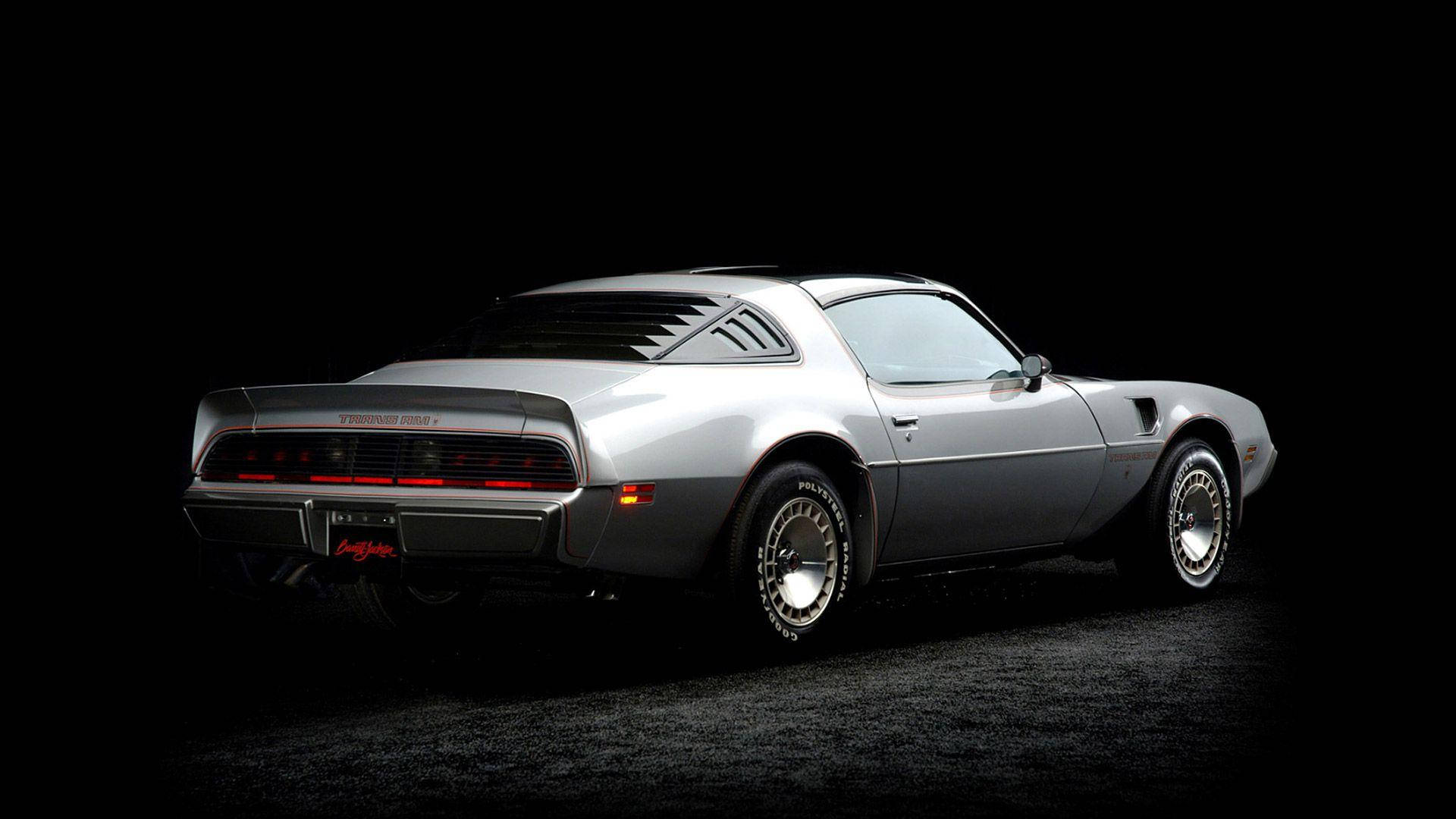 1979銀色龐蒂克火鳥 壁紙 — 一架流線型的銀色 Pontiac Trans Am 肌肉車在黑色背景的攝影棚燈光下閃耀。