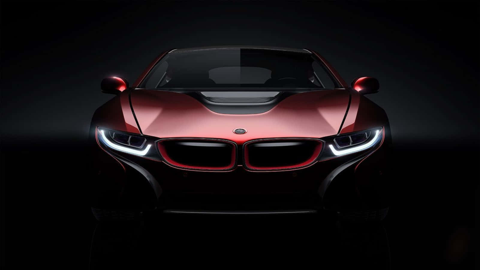 紅色BMW i8跑車在黑暗的攝影棚環境中帶有發光的前燈。