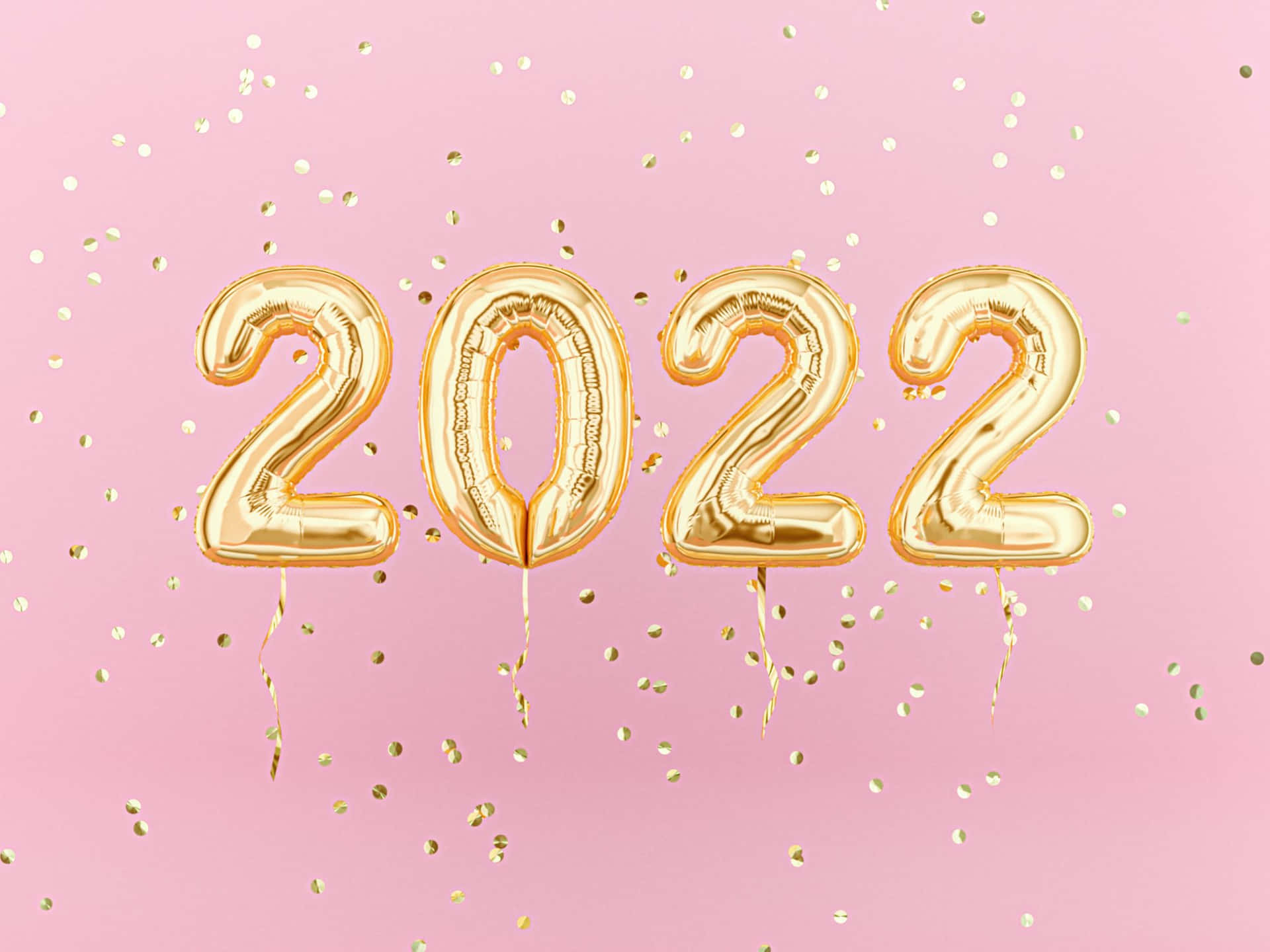 金色2022氣球與五彩紙屑在粉紅色背景上