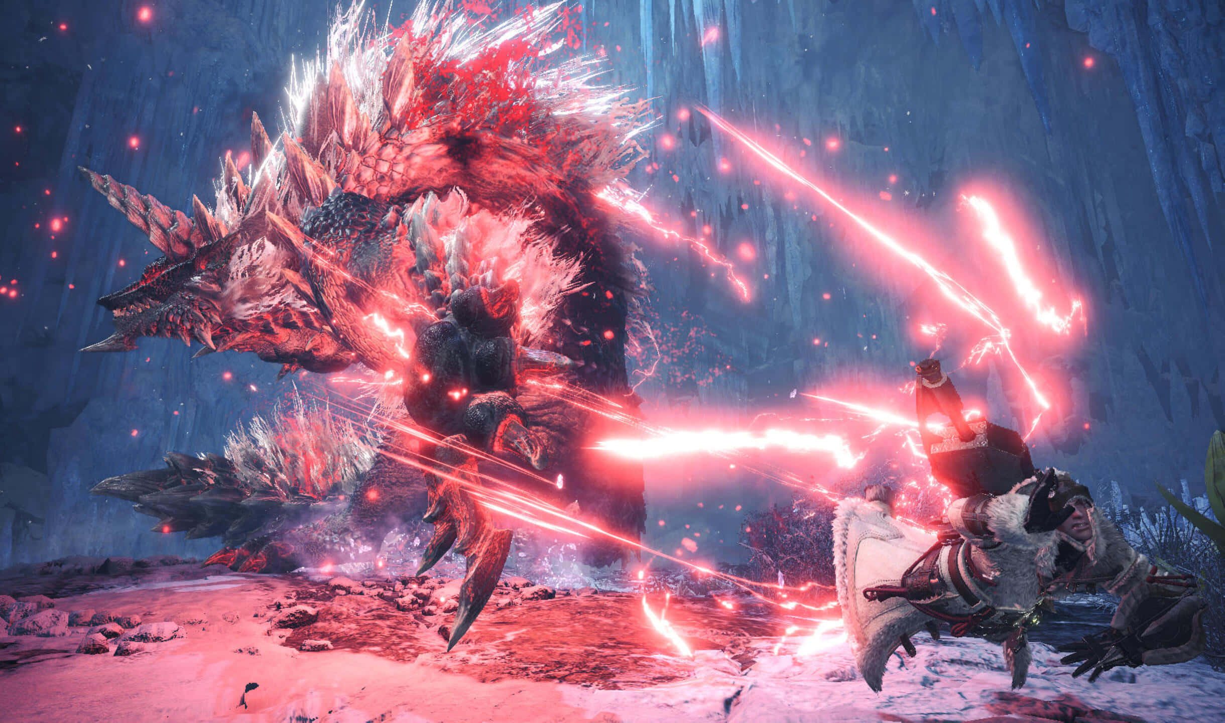 2440x1440 Monster Hunter World Brachydios 背景 壁紙 — 一名身穿裝甲的獵人在雪洞中與一隻巨大的發光紅色怪物戰鬥，電火花四濺。