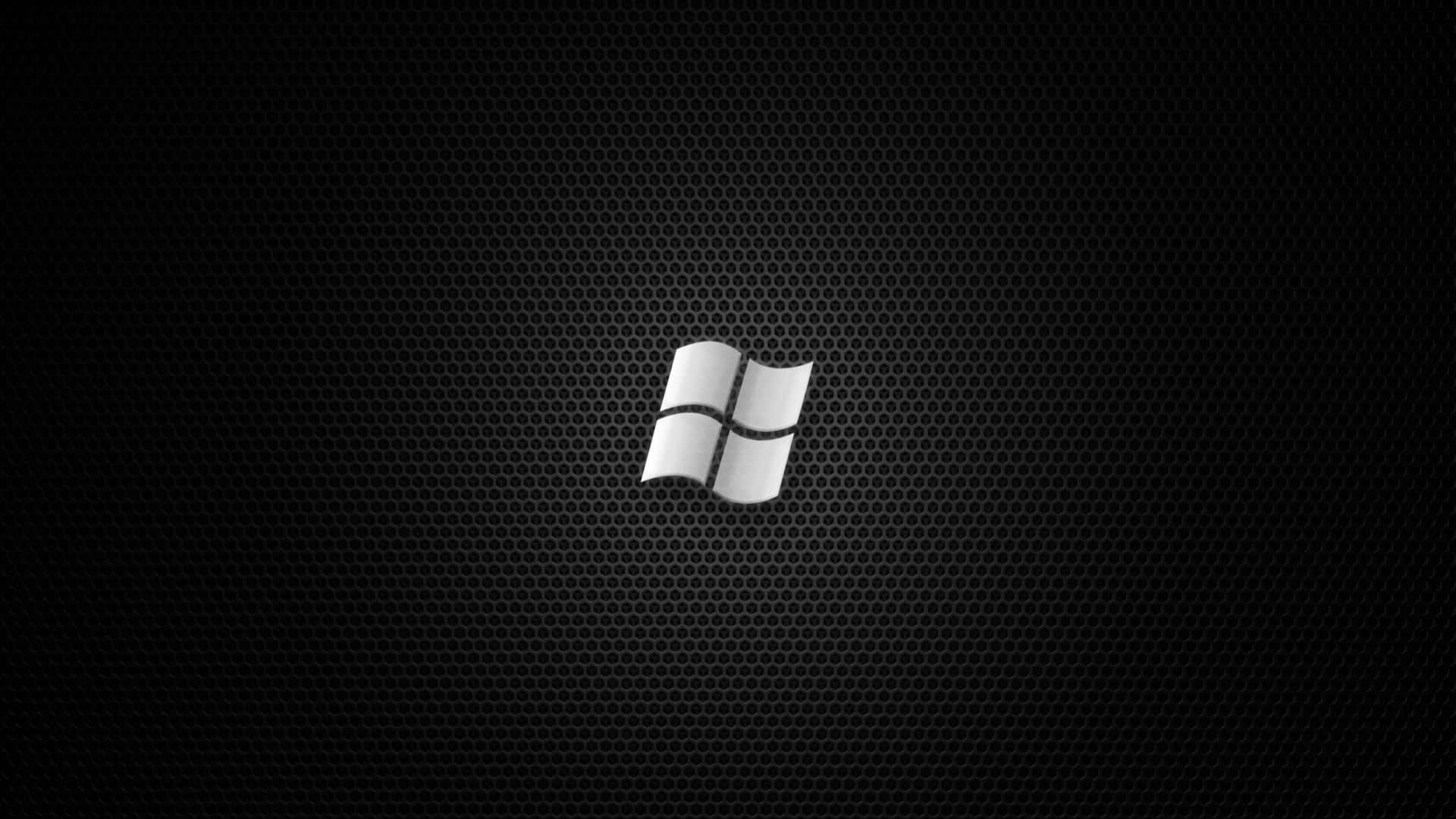 銀色Windows標誌在黑色穿孔金屬背景上。