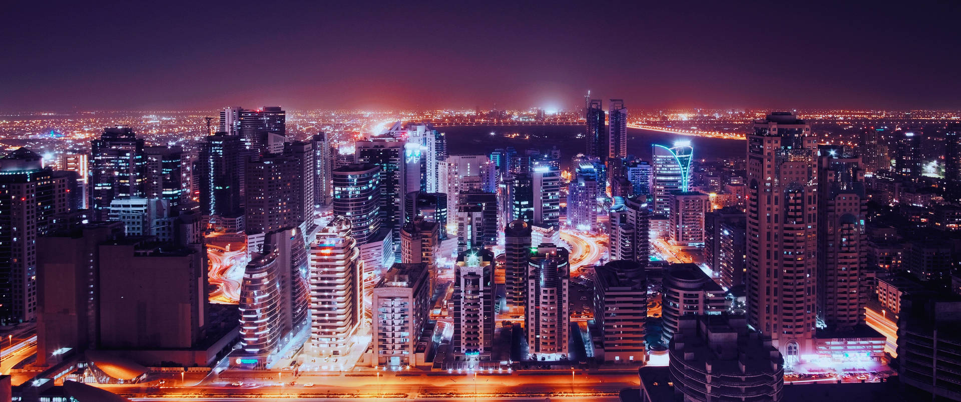 夜晚廣闊的城市，發光的建築與繁忙的街道。