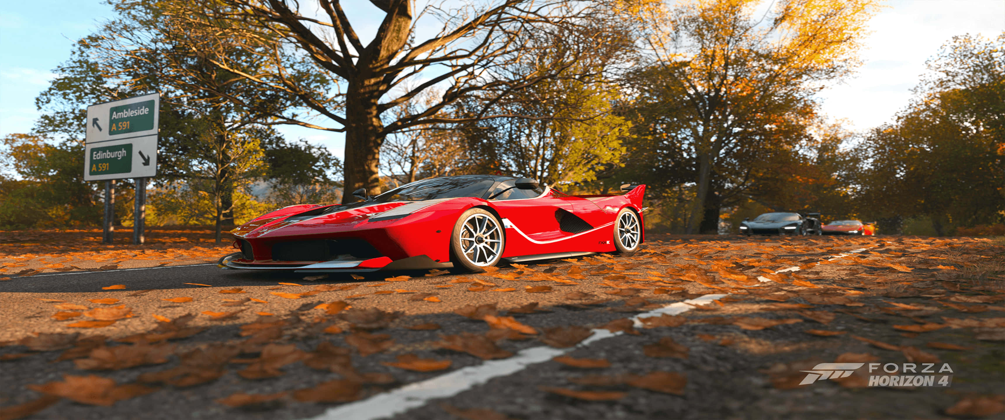 3440x1440p《Forza Horizon 4》賽車遊戲背景 壁紙 — 一輛紅色法拉利SF90 Stradale停泊在秋季樹木下鋪滿落葉的道路上，帶有Forza Horizon 4水印。