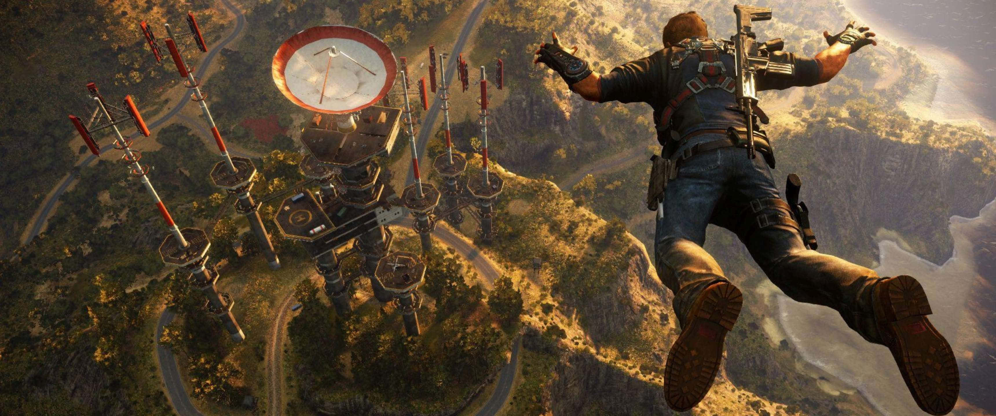 3440x1440p《Just Cause 4》高畫質壁紙 壁紙 — 一名士兵在山上自由落體，朝向一個帶有紅色天線的巨大鐘樓。