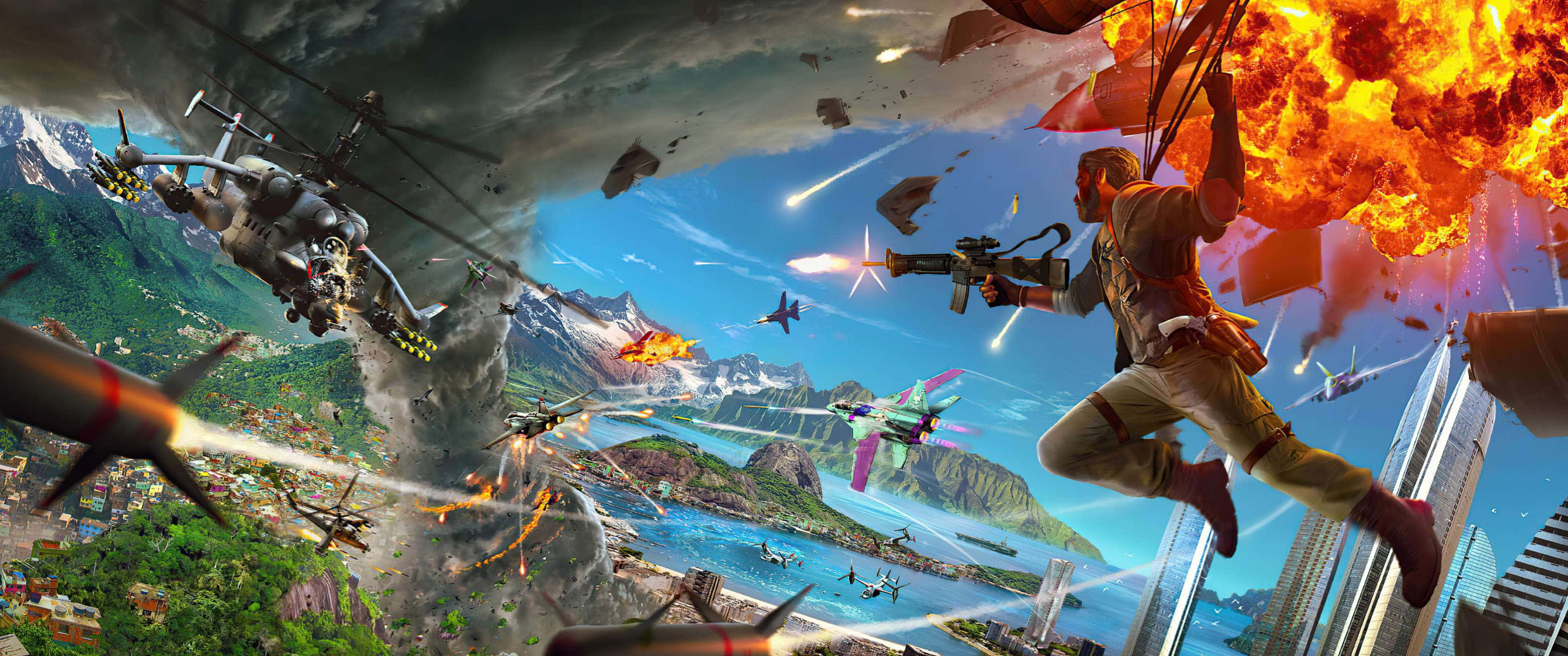 3440x1440p《Just Cause 4》空中大戰背景 壁紙 — 一名士兵跳過一個混亂的戰場，爆炸、直升機和噴射機在一個多山的沿海城市上空開火。