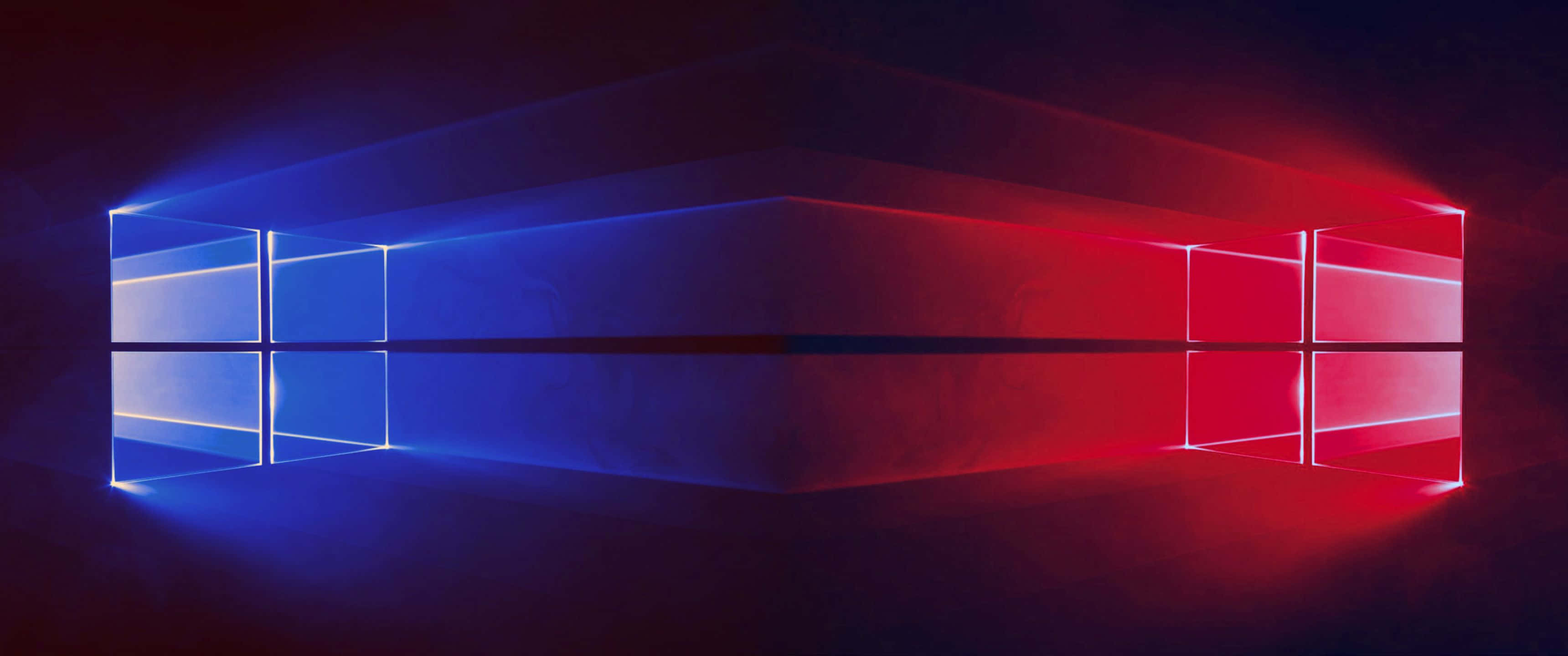 3440x1440p 靜謐自然風景 壁紙 — 發光的藍色和紅色Windows標誌在黑暗煙霧背景上散發光芒。