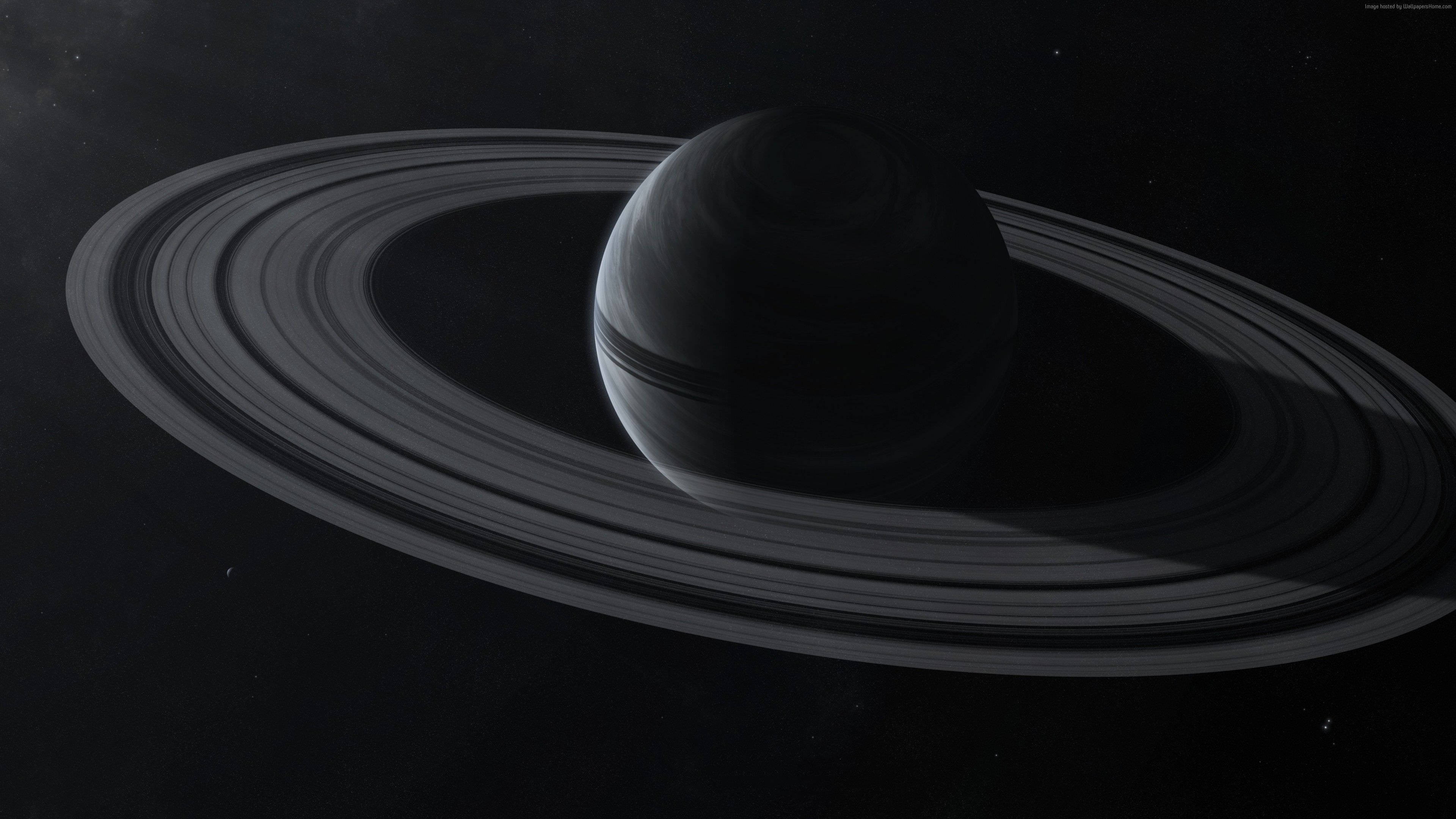 3D 黑色土星 壁紙 — 土星的單色視圖，其標誌性光環在太空虛空中柔和發光。