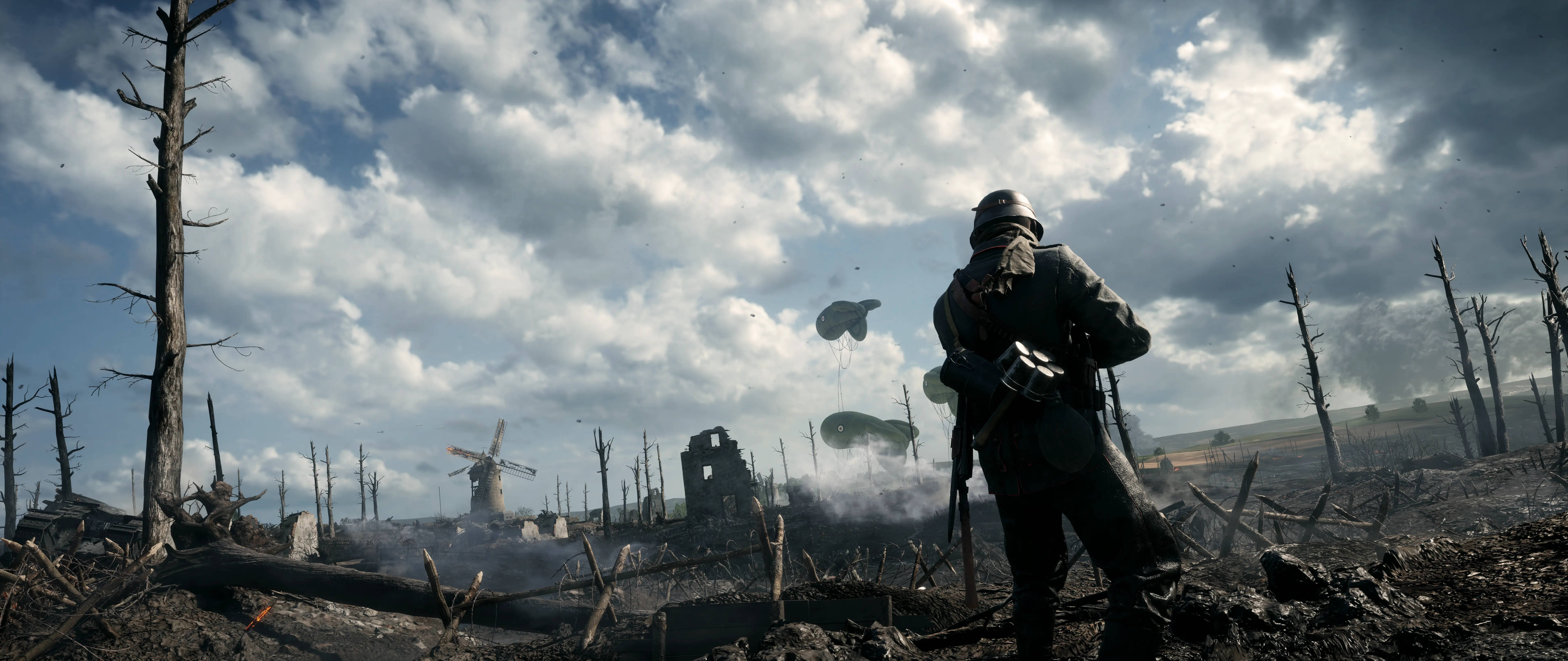 4K BF1 德國無人區 壁紙 — 一名士兵站在荒涼的戰亂田野中，周圍是廢墟建築和枯樹，天空多雲，降落傘正在下降。