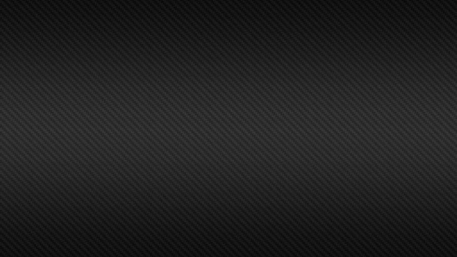 碳纖維 4K 壁紙 — 光滑黑色碳纖維紋理，帶有斜紋編織圖案和微妙的漸變照明。
