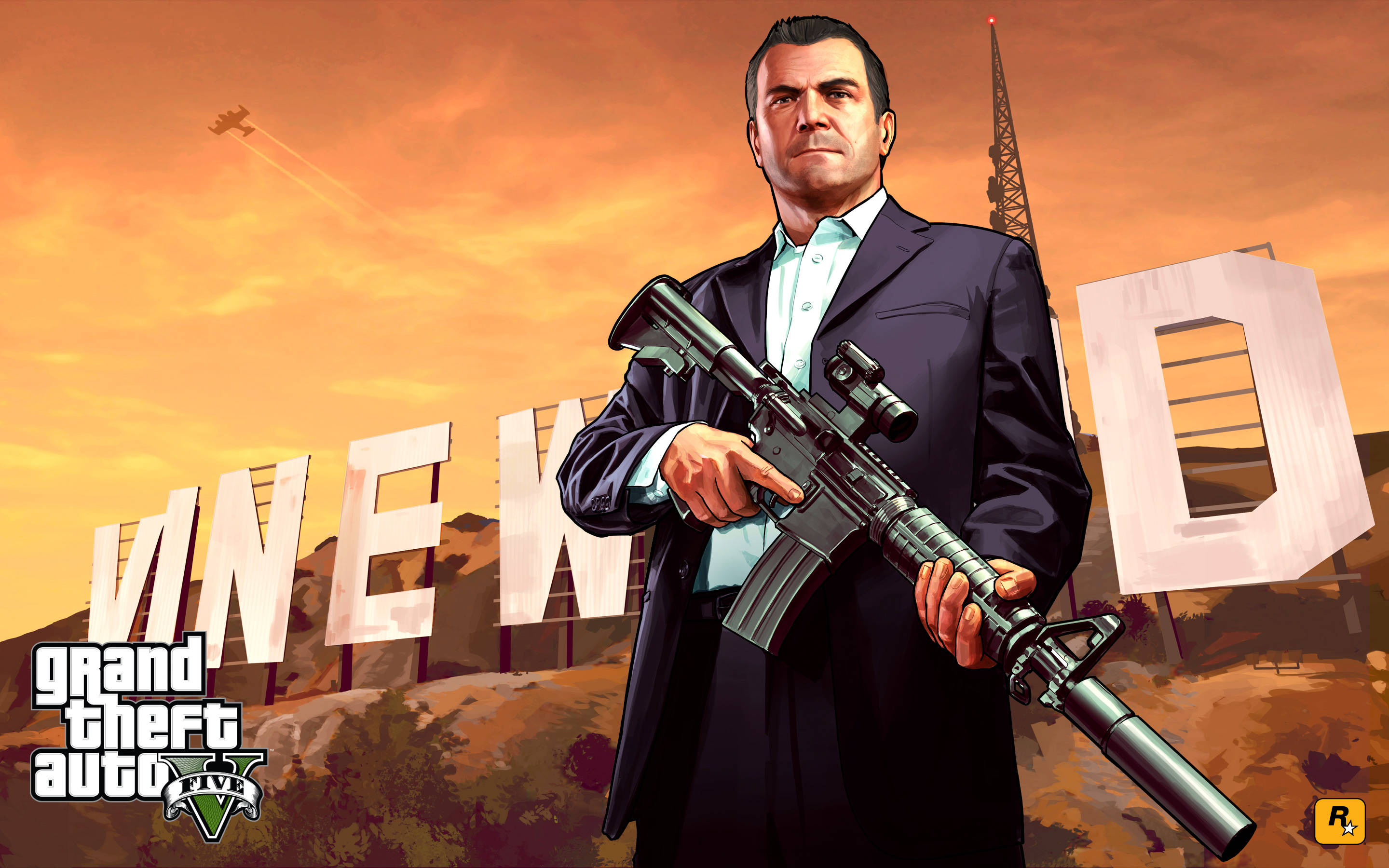 4K GTA 5 迈克尔持槍對準文威德招牌 壁紙 — 一名穿西裝的男子在日落背景下持步槍，背景有「VINEWOOD」標誌和飛行的飛機。