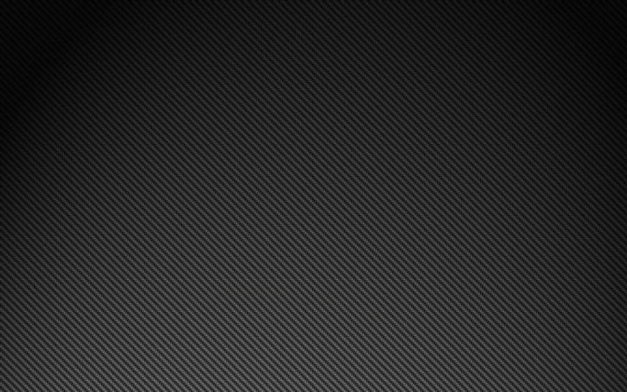 碳纖維 4K 壁紙 — 從深灰色到淺灰色的對角碳纖維紋理漸變，帶有微妙光澤。