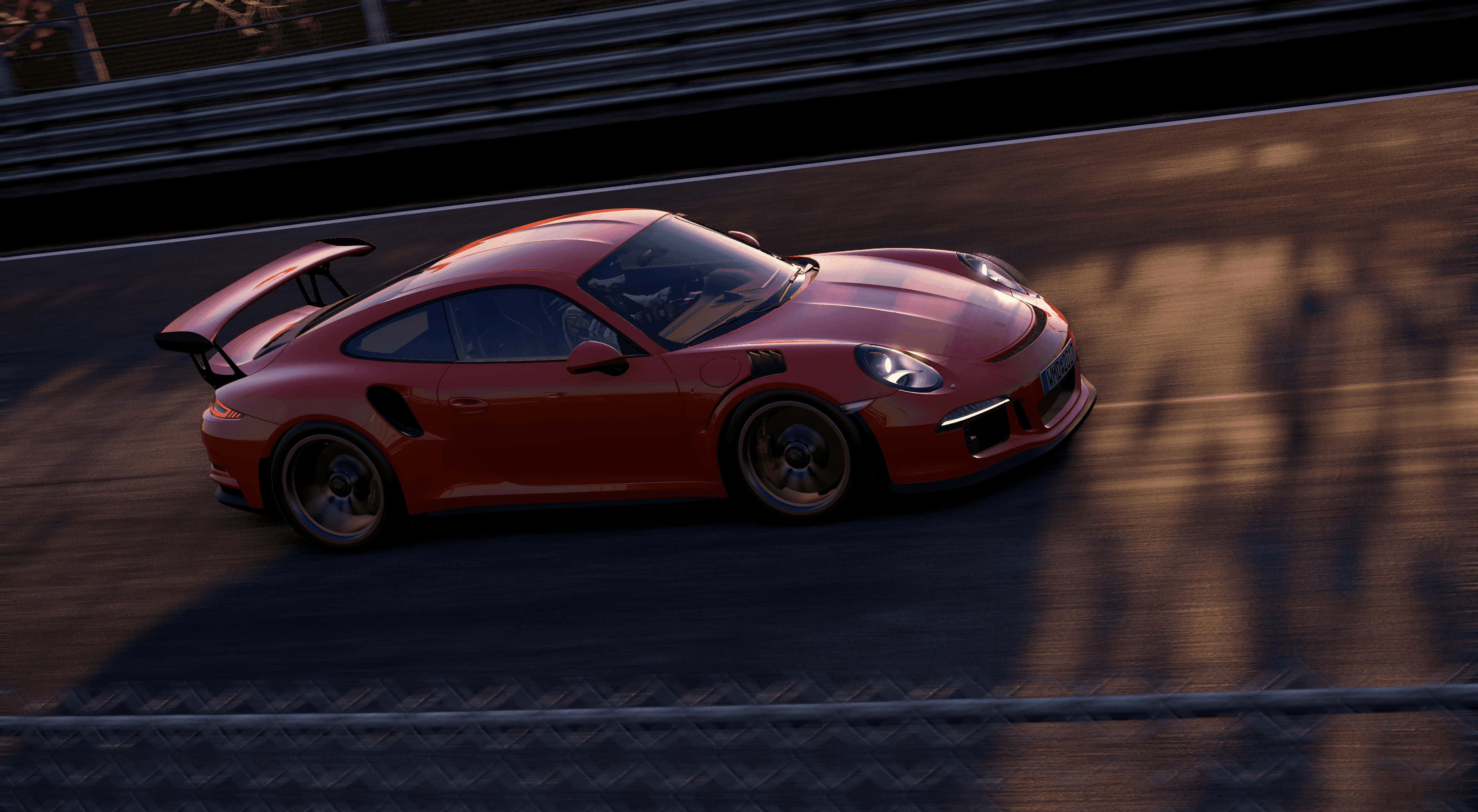 4K Project Cars 紅色 2016 年保時捷 911 GT3 RS 背景 壁紙 — 一輛鮮紅色的保時捷911 GT2 RS在日落時分沿著賽道飛馳，在瀝青上投下長長的影子。