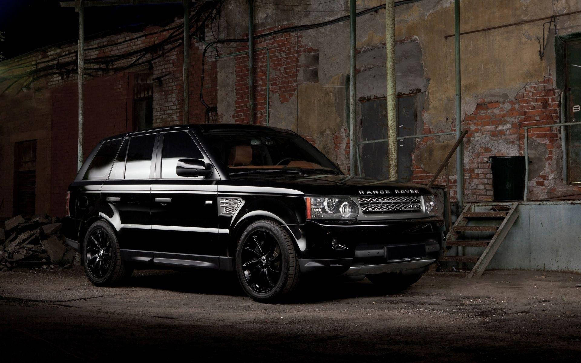 黑色Range Rover SUV停泊在黑暗的廢棄工業倉庫中。