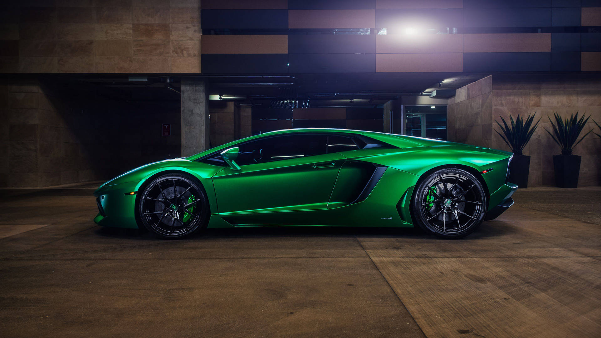 一輛綠色林寶堅尼 Aventador 停放在燈光昏暗的地下車庫中。
