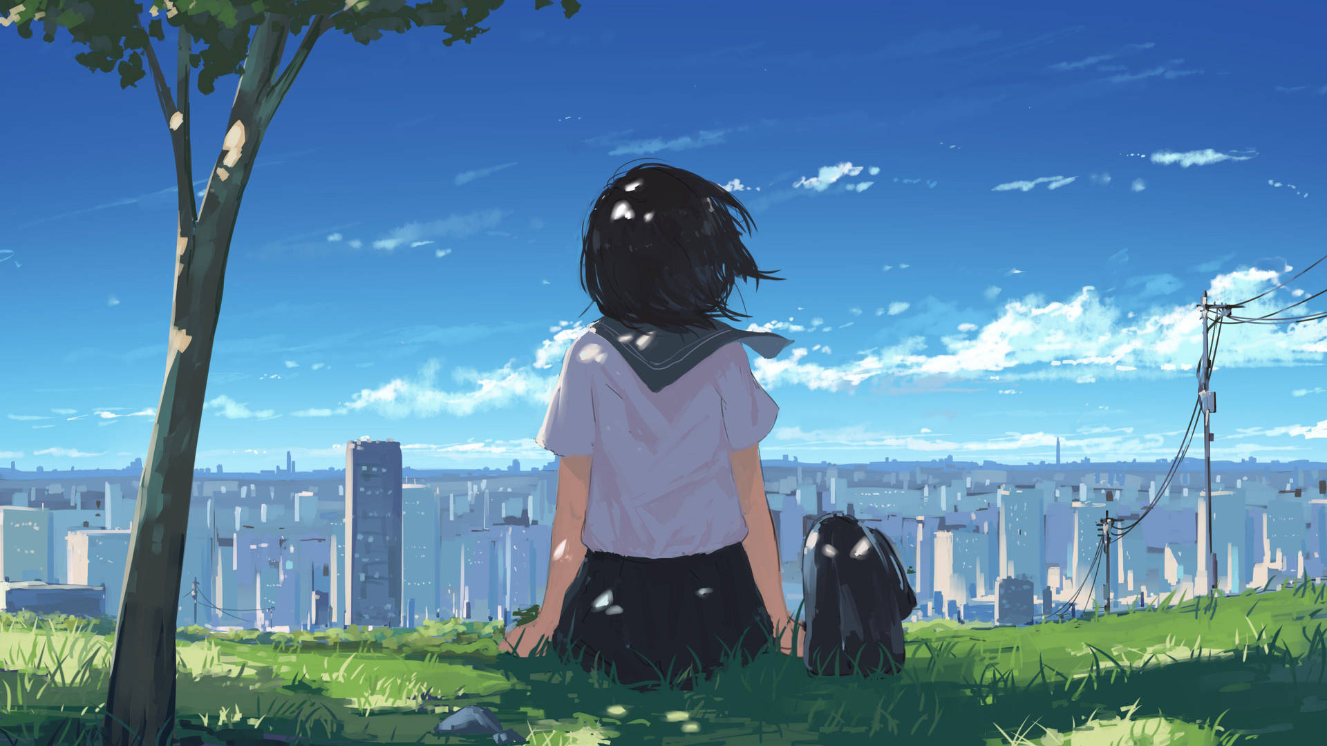 穿著校服的女孩坐在草地上從山丘俯瞰城市