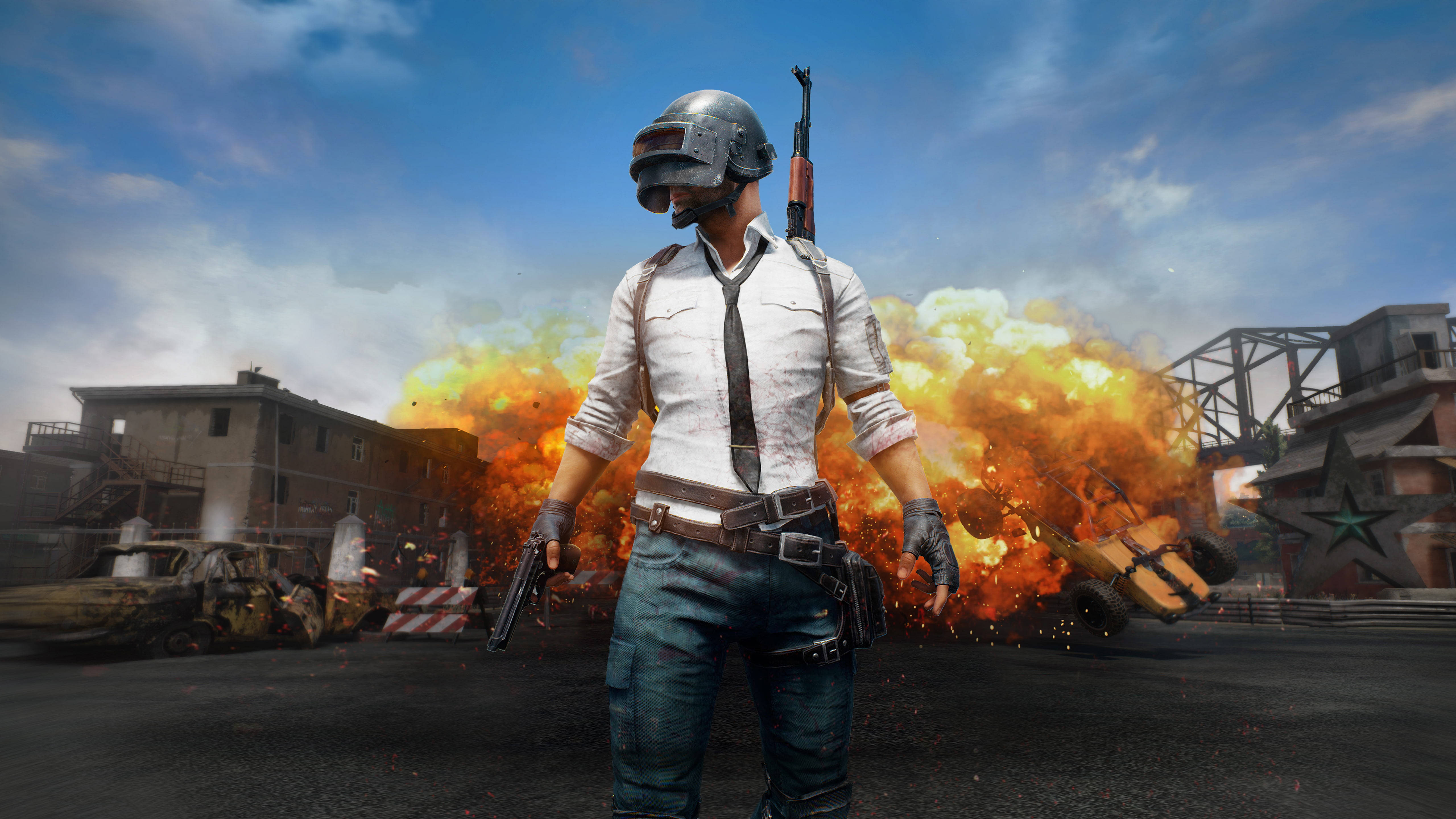 5K 高清 PUBG 封面 壁紙 — 一名戴頭盔和領帶的士兵站在戰火摧殘的城市街道上，身處爆炸和瓦礫之中。