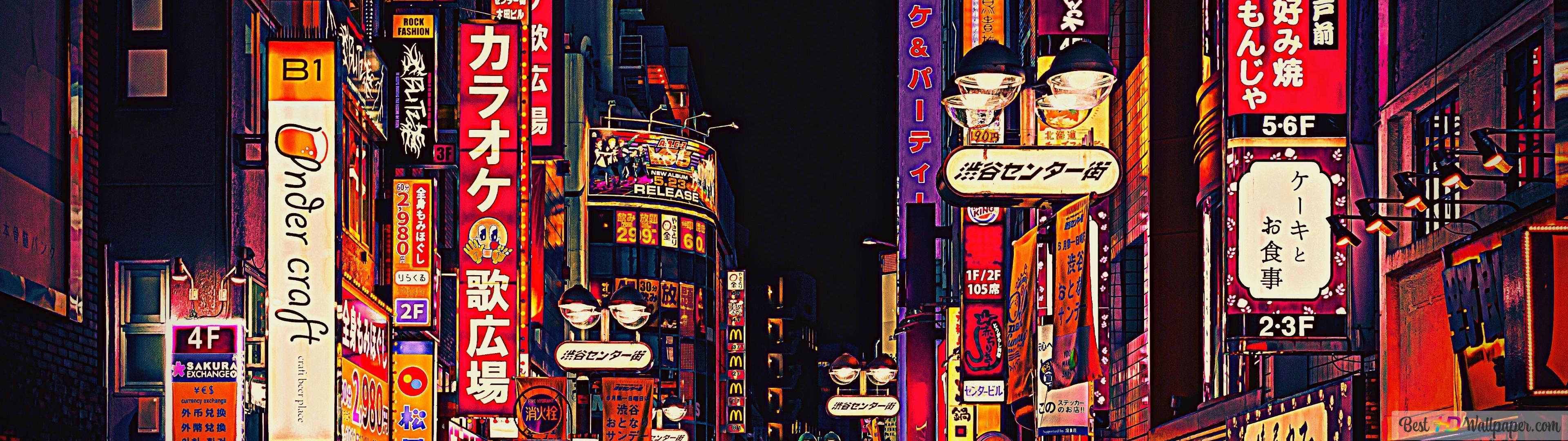 霓虹燈照亮夜晚的東京街道，發光的招牌和潮濕路面的倒影。 — 東京 壁紙