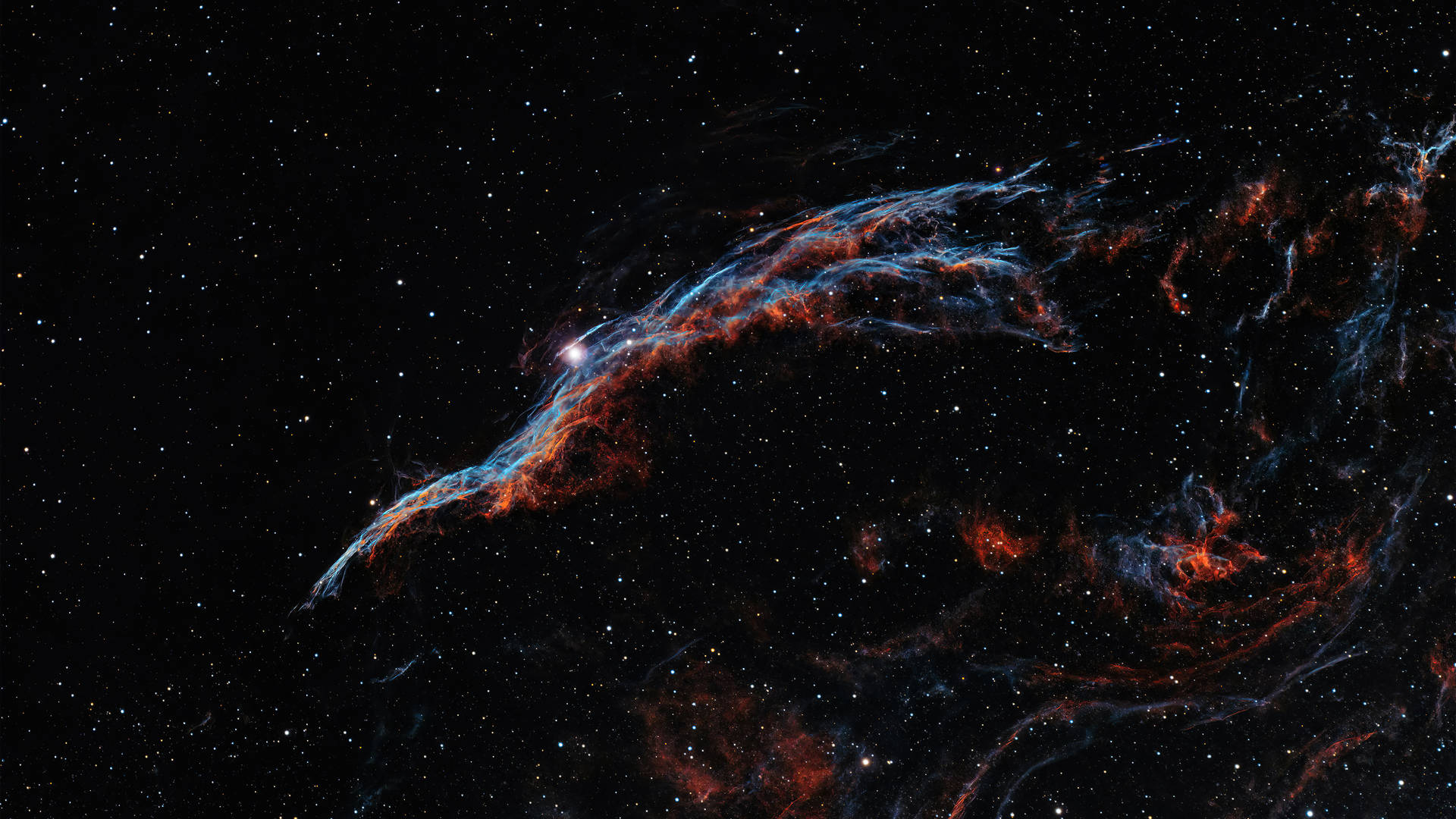 在深空中，鮮豔的紅色和藍色星雲在遙遠的星星之間發光。