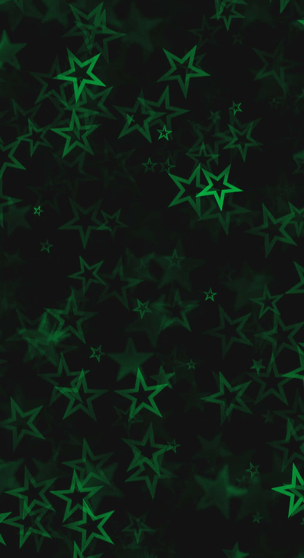  壁紙 — 一個深色背景，充滿了不同大小和不透明度的發光綠色星星，形成宇宙圖案。