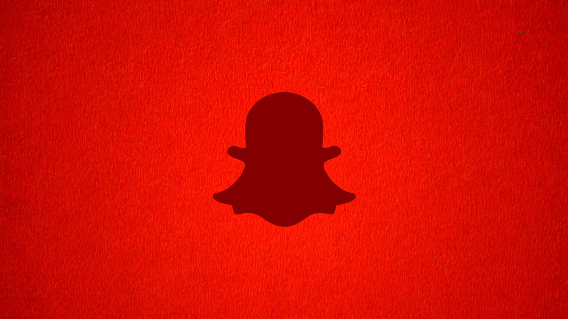  壁紙 — 一個深紅色Snapchat鬼魂標誌，居中於帶紋理的鮮紅色背景上。