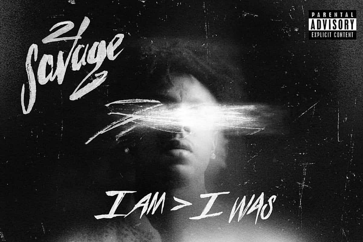 專輯封面，人臉部分被光遮擋，文字寫著「Savage」和「I AM > I WAS」。