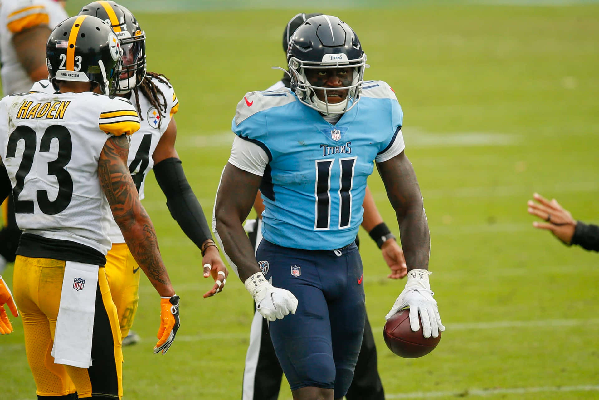 NFL比賽中，田納西泰坦隊11號球員帶著美式足球奔跑。