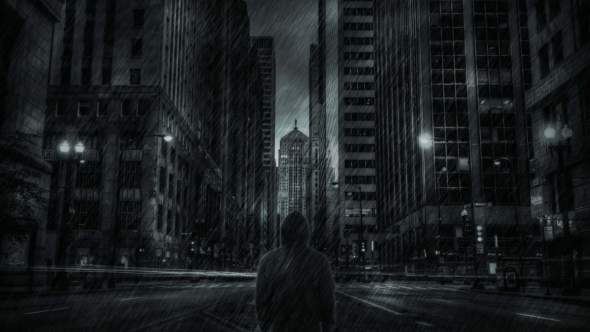 一個穿連帽衫的人在夜晚獨自走在雨中的城市。