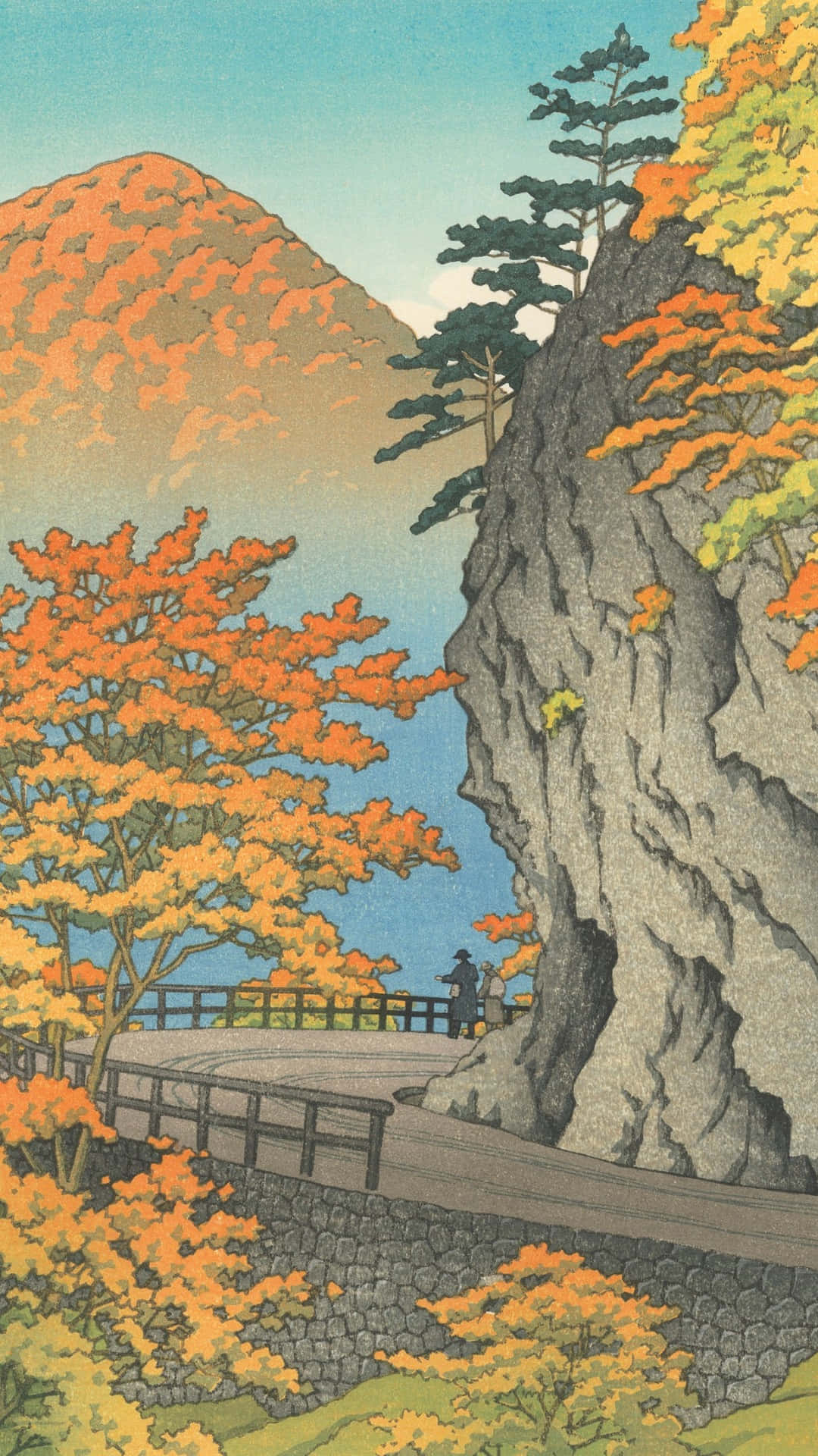  壁紙 — 一位孤獨的旅人沿著一條蜿蜒穿過鮮豔秋葉的石徑行走，背景是高聳的懸崖和遠山。