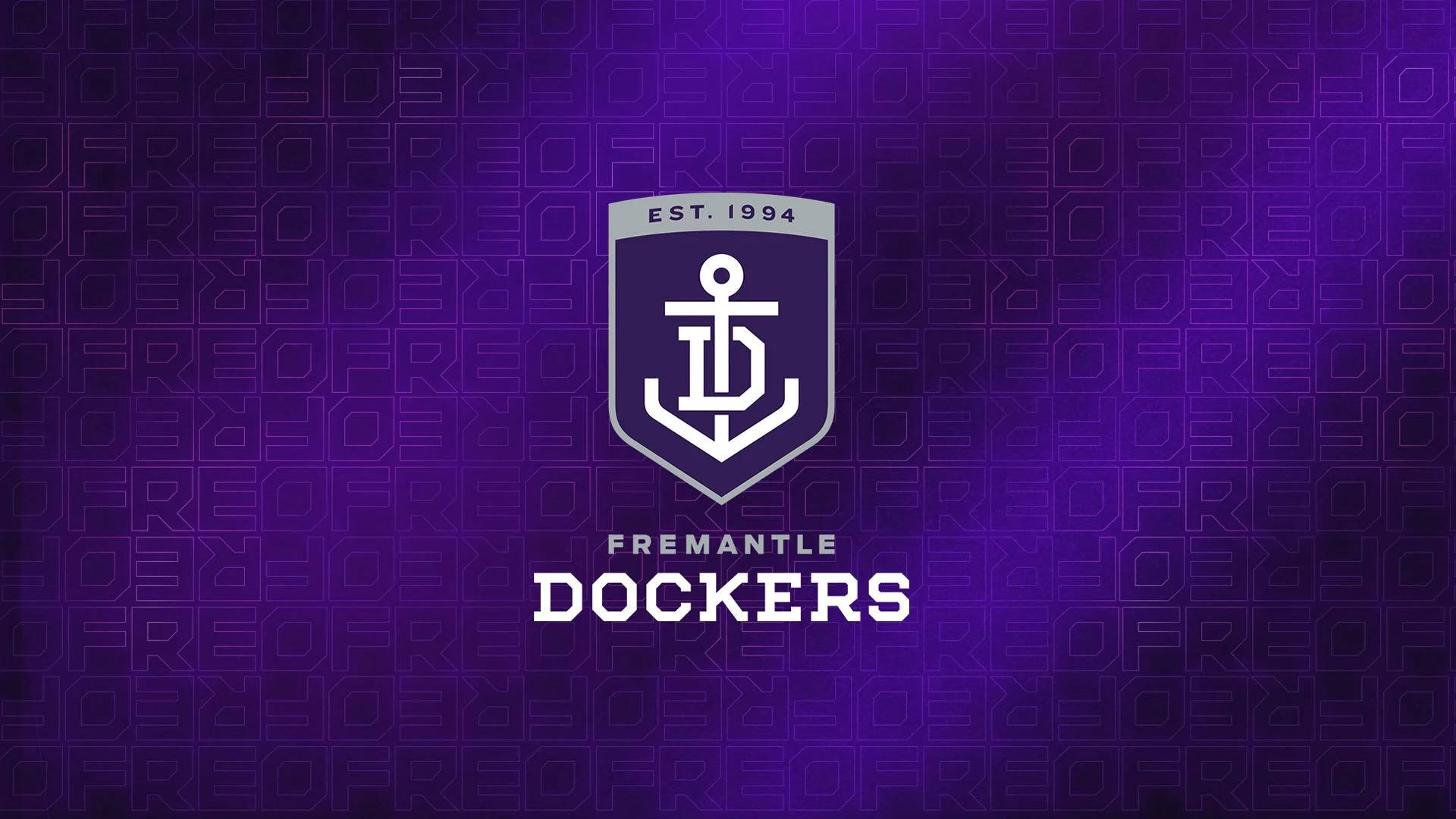 AFL弗雷曼特爾海鷹隊 壁紙 — 紫色漸變牆紙，帶有費利曼圖碼頭工人隊標誌及背景中重複的微妙文字圖案。