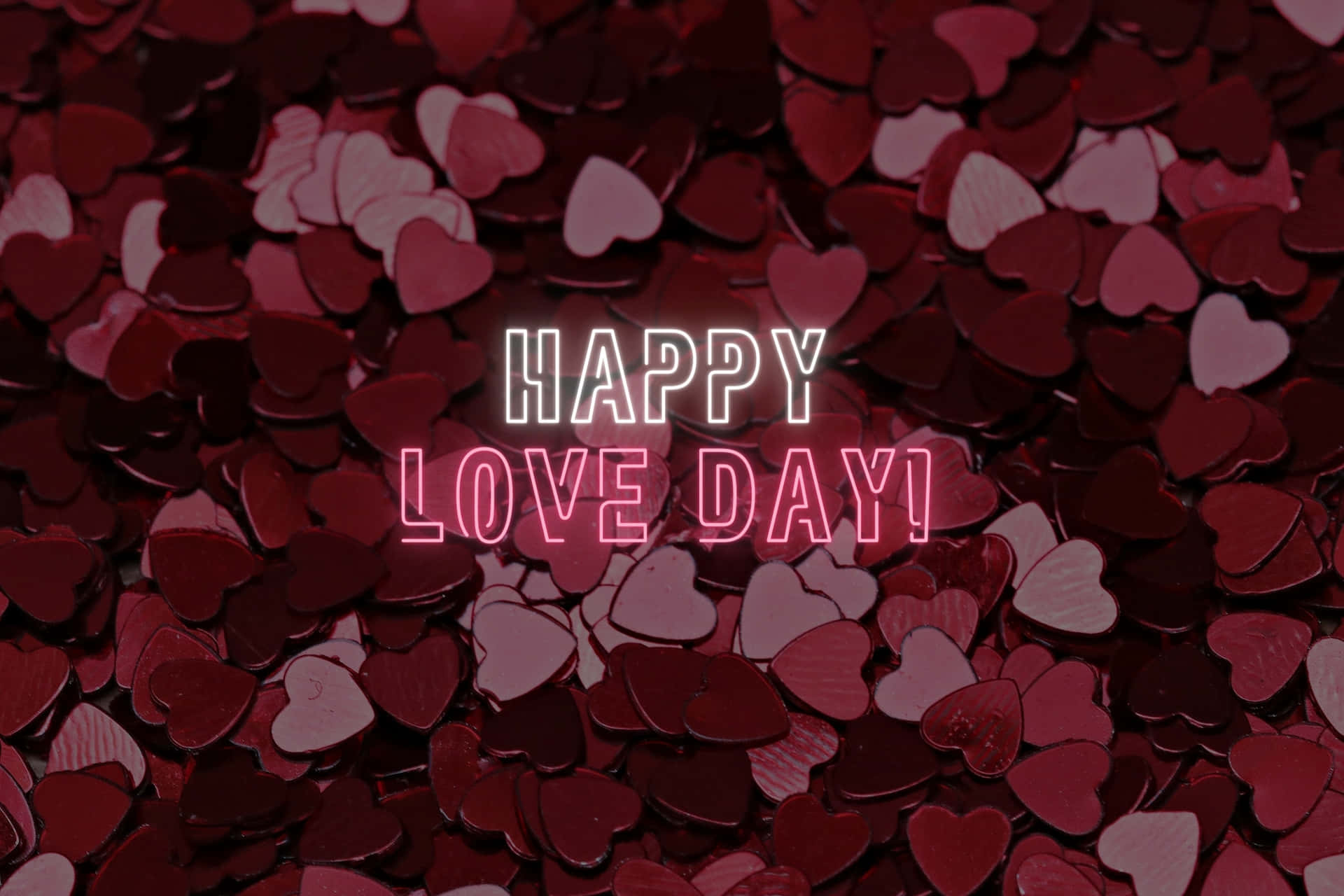  壁紙 — 一片紅色和粉紅色心形紙屑的海洋，帶有發光霓虹文字 'HAPPY LOVE DAY!'
