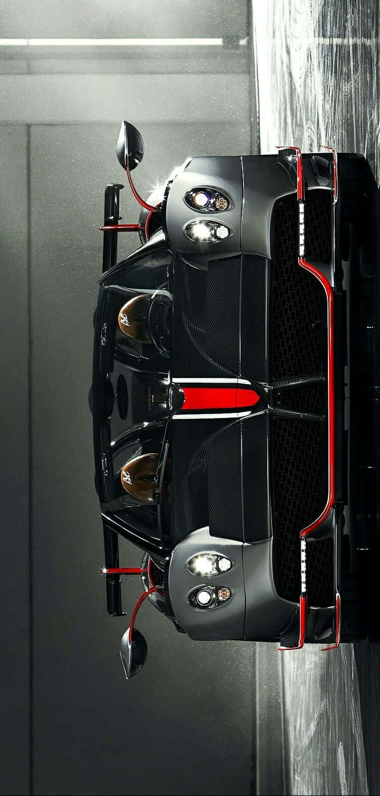 Pagani Zonda C12 Roadster 桌布 壁紙 — 一架時尚的黑色和紅色超跑倒掛在極簡車庫中，帶有戲劇性的燈光。