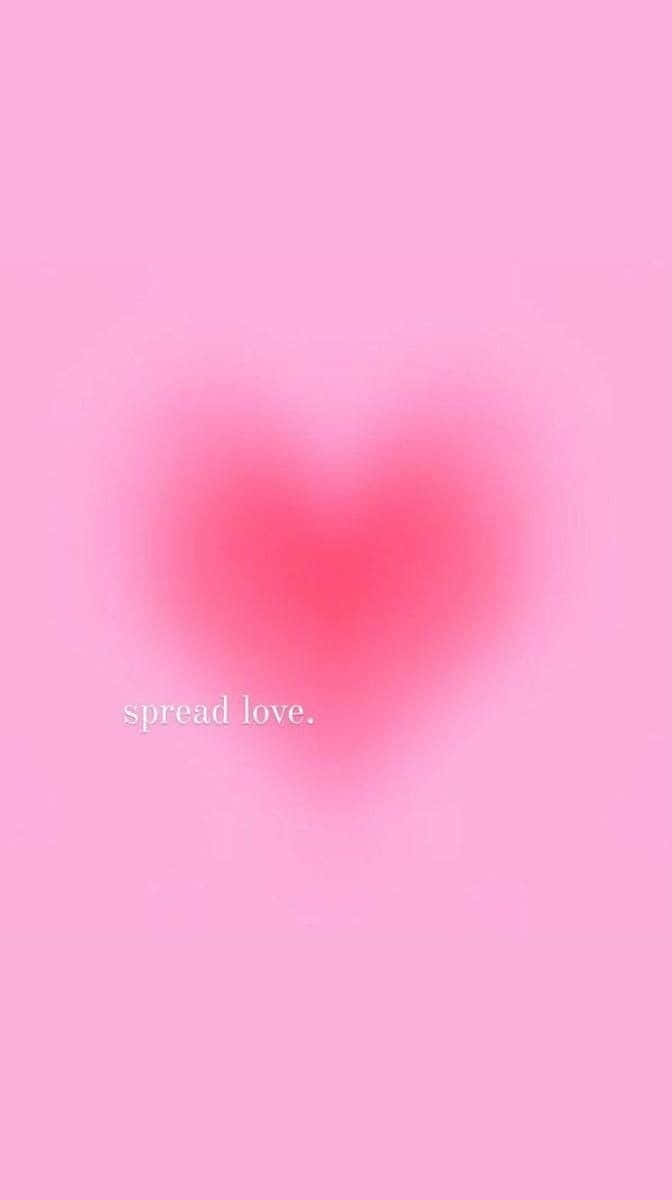 粉紅色背景上有一個模糊的心形和文字 spread love。 — 粉紅色心形動圖 壁紙
