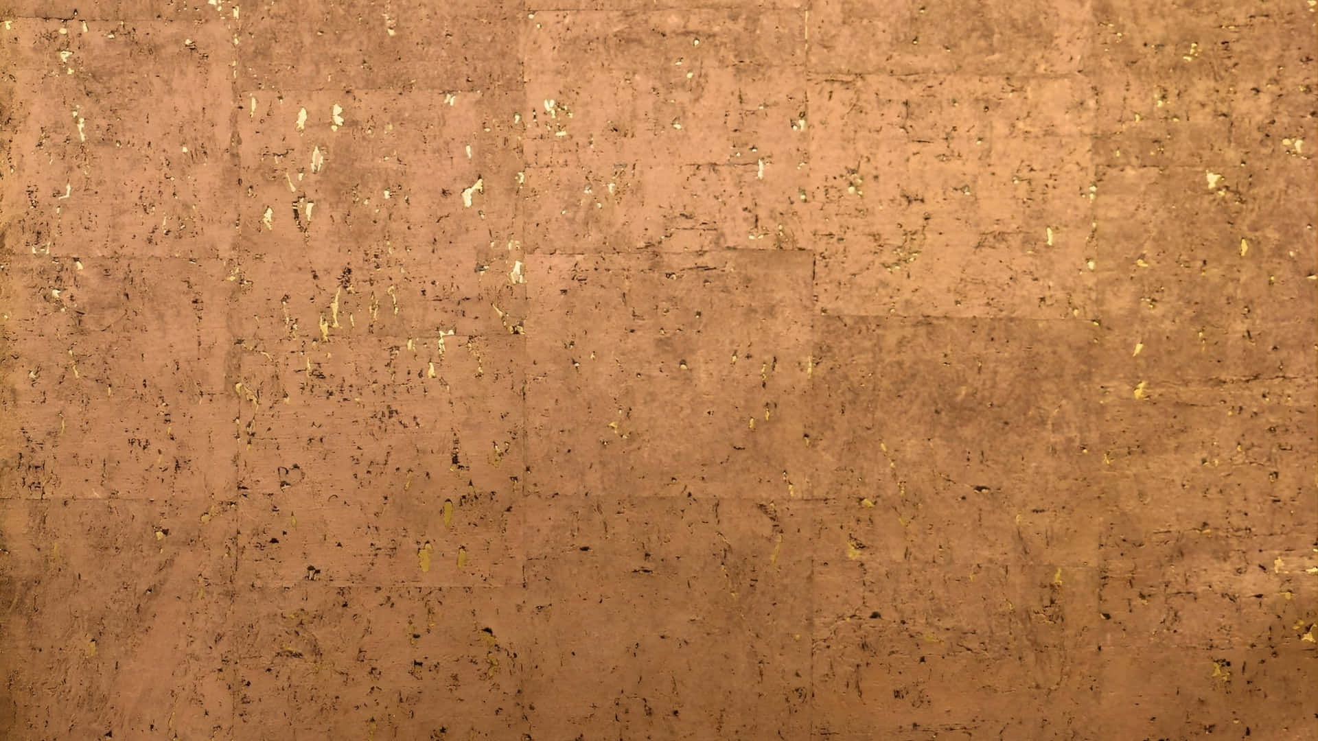  壁紙 — 帶有紋理的銅色表面，散落著金色斑點和微妙的接縫。