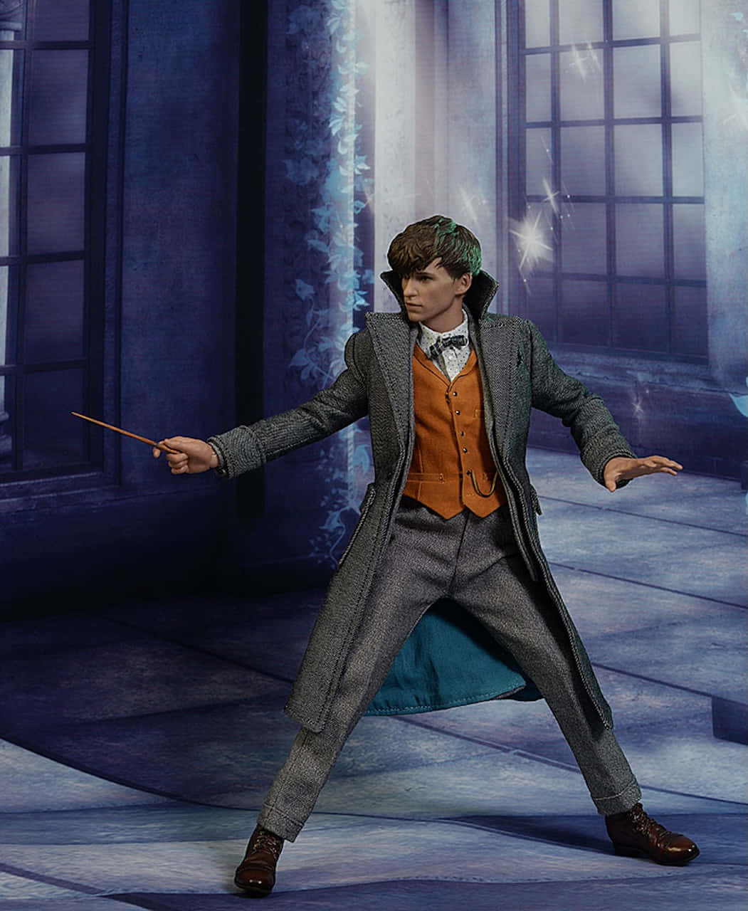  壁紙 — 一位身穿灰色外套和橙色背心的巫師，在光線昏暗的石室中用魔杖施展法術，伴隨著發光的魔法效果。