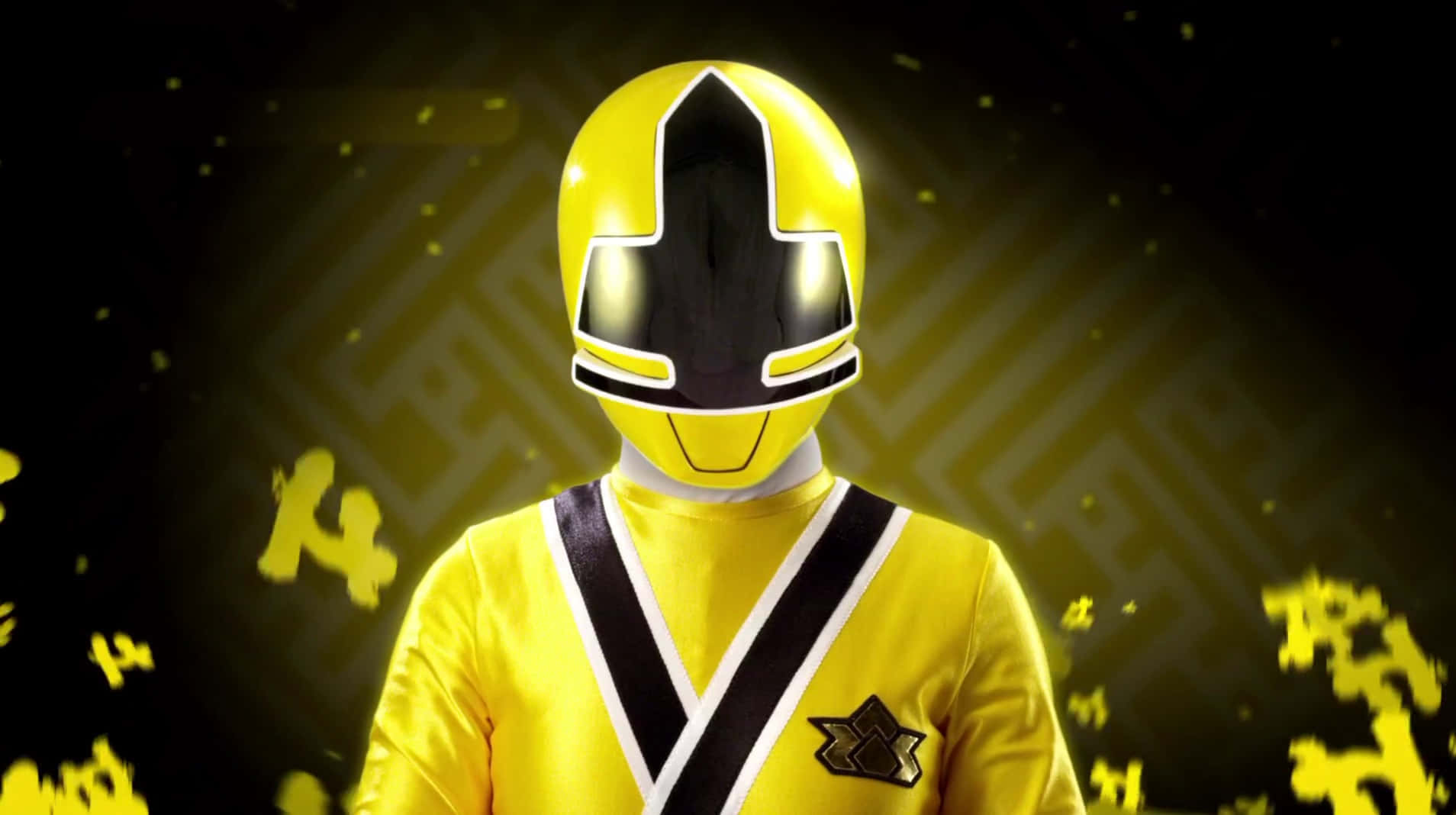  壁紙 — 一位黃色Power Ranger全副武裝站在深色背景前，帶有發光的黃色粒子和幾何圖案。