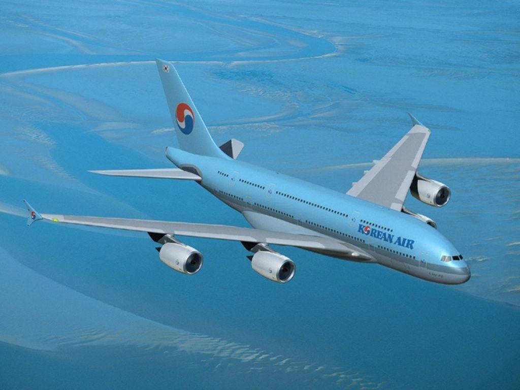 韓亞航空空中巴士 A330-200 壁紙 — 大韓航空的空中巴士A340在廣闊的藍色海洋上空優雅翱翔，下方有蜿蜒的白色沙洲。