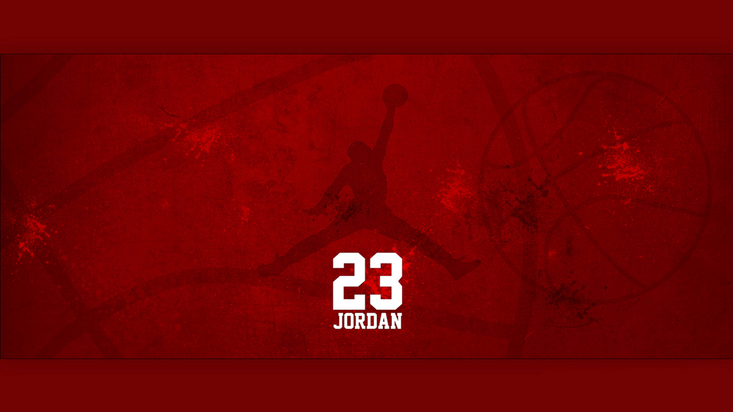 Air Jordan 標誌籃球 壁紙 — 一張大膽的紅色紋理牆紙，上面有米高佐敦在半空中入樽的剪影，下方有23號和他的名字。
