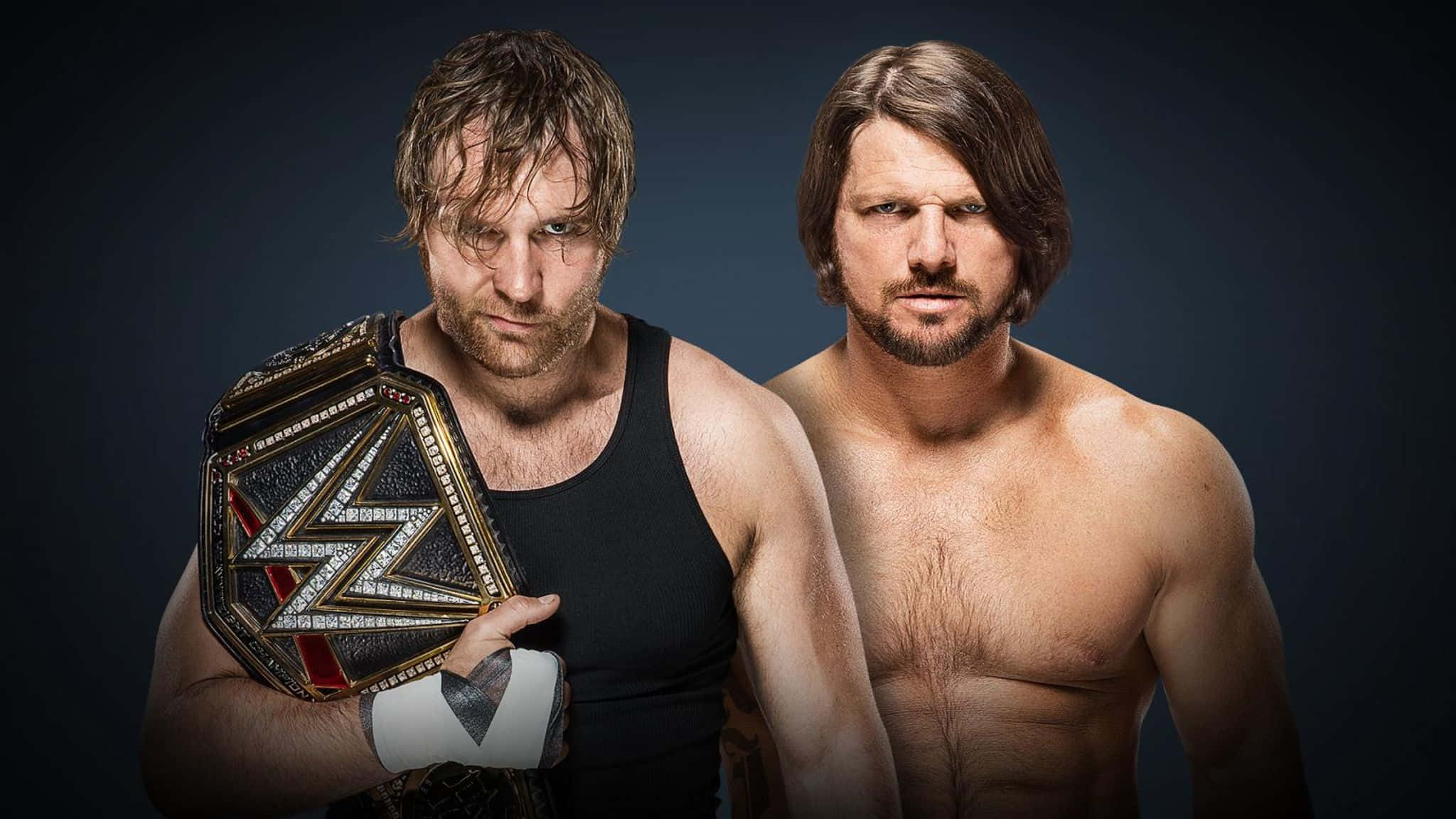 AJ Styles Jon Moxley海報設計 壁紙 — 兩位激烈的WWE摔角手向前凝視，其中一人手持冠軍腰帶，背景為黑暗的攝影棚。