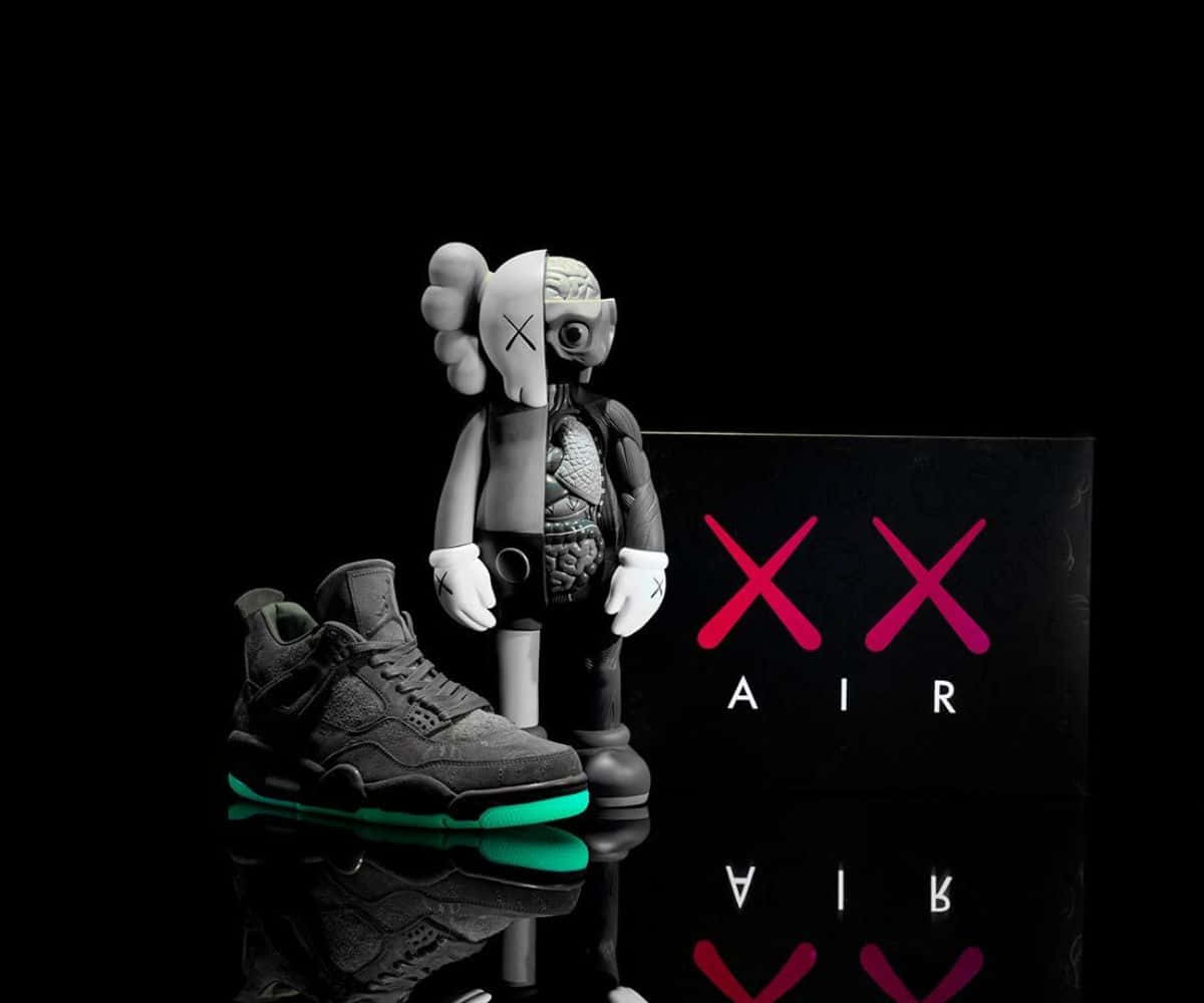 Kaws X Air Jordan 桌布 壁紙 — AKA kaws 公仔內臟外露，站在一對黑色運動鞋旁邊，鞋底發出綠色螢光，置於反光表面上。