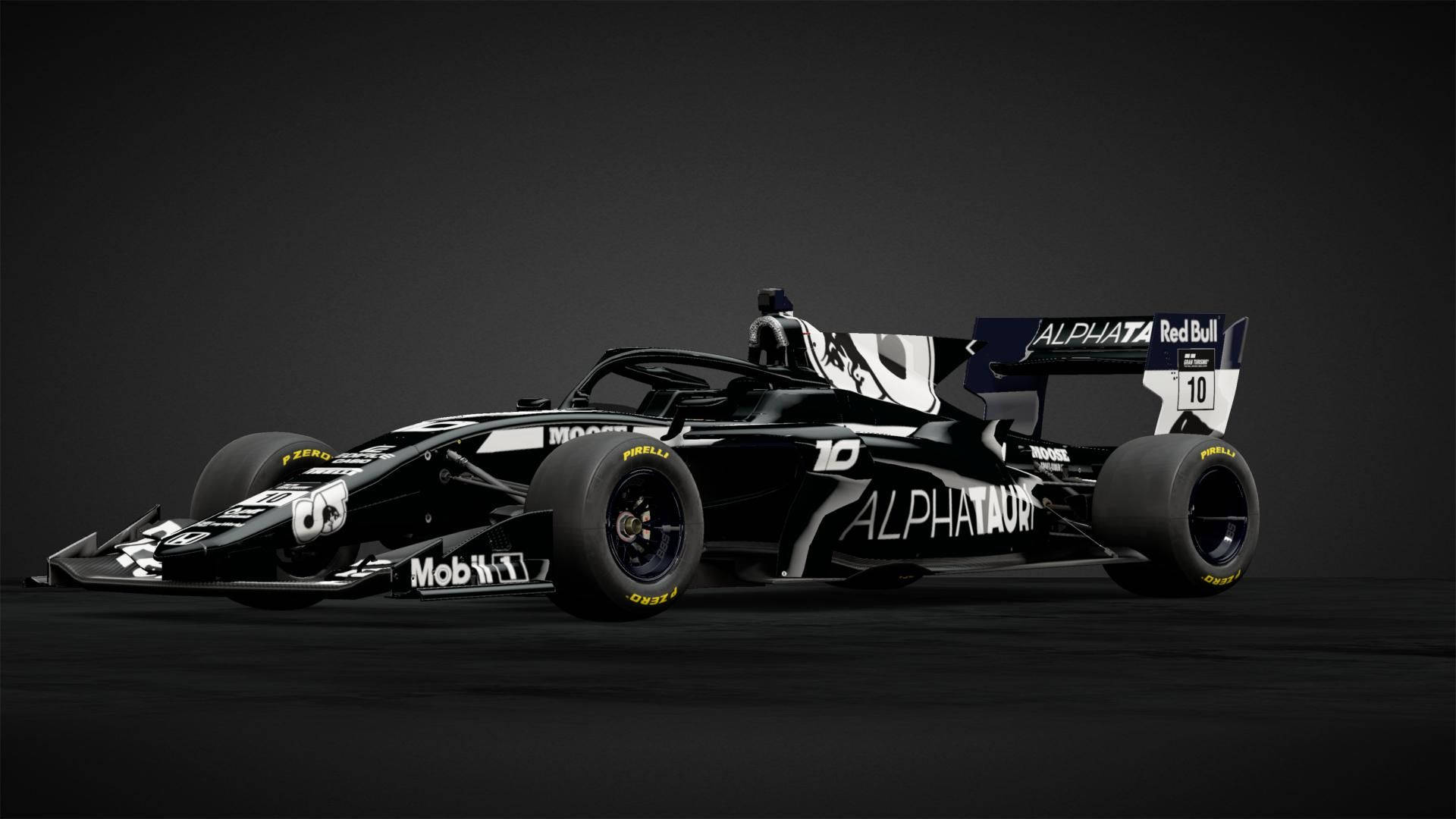 黑暗攝影棚地板上的黑白AlphaTauri F1賽車，編號10。
