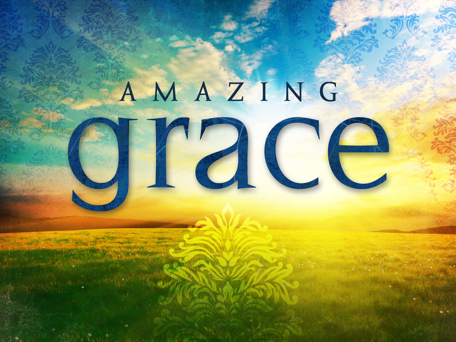 grace 桌布 壁紙 — 「amazing grace」字樣飄浮在陽光照耀的田野上，天空和前景帶有華麗的花卉圖案。