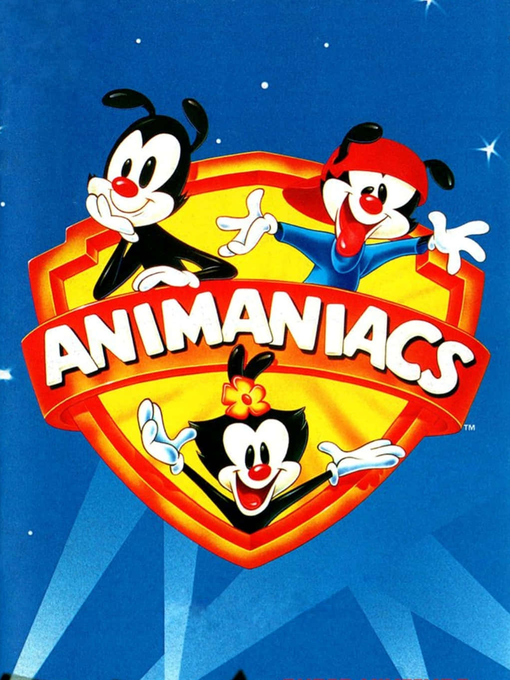 Animaniacs 的 Wakko、Yakko 和 Dot 以獨特方式帶來幽默！ 壁紙 — 三個卡通角色在一個盾牌標誌中，背景是星空藍色，帶有鮮明的紅色、黃色和白色。